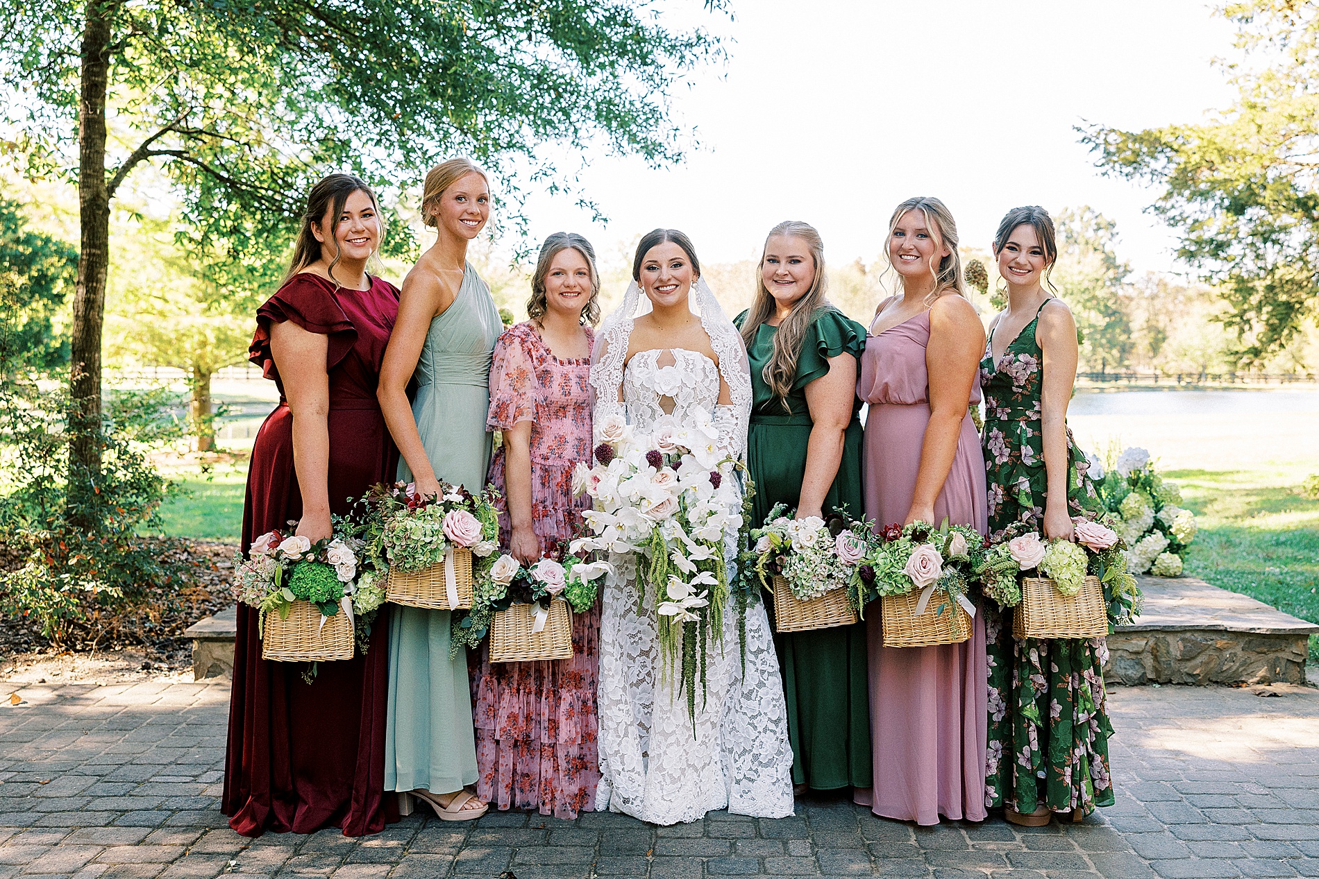 bride with bridesmaids holding bouquets in basket 