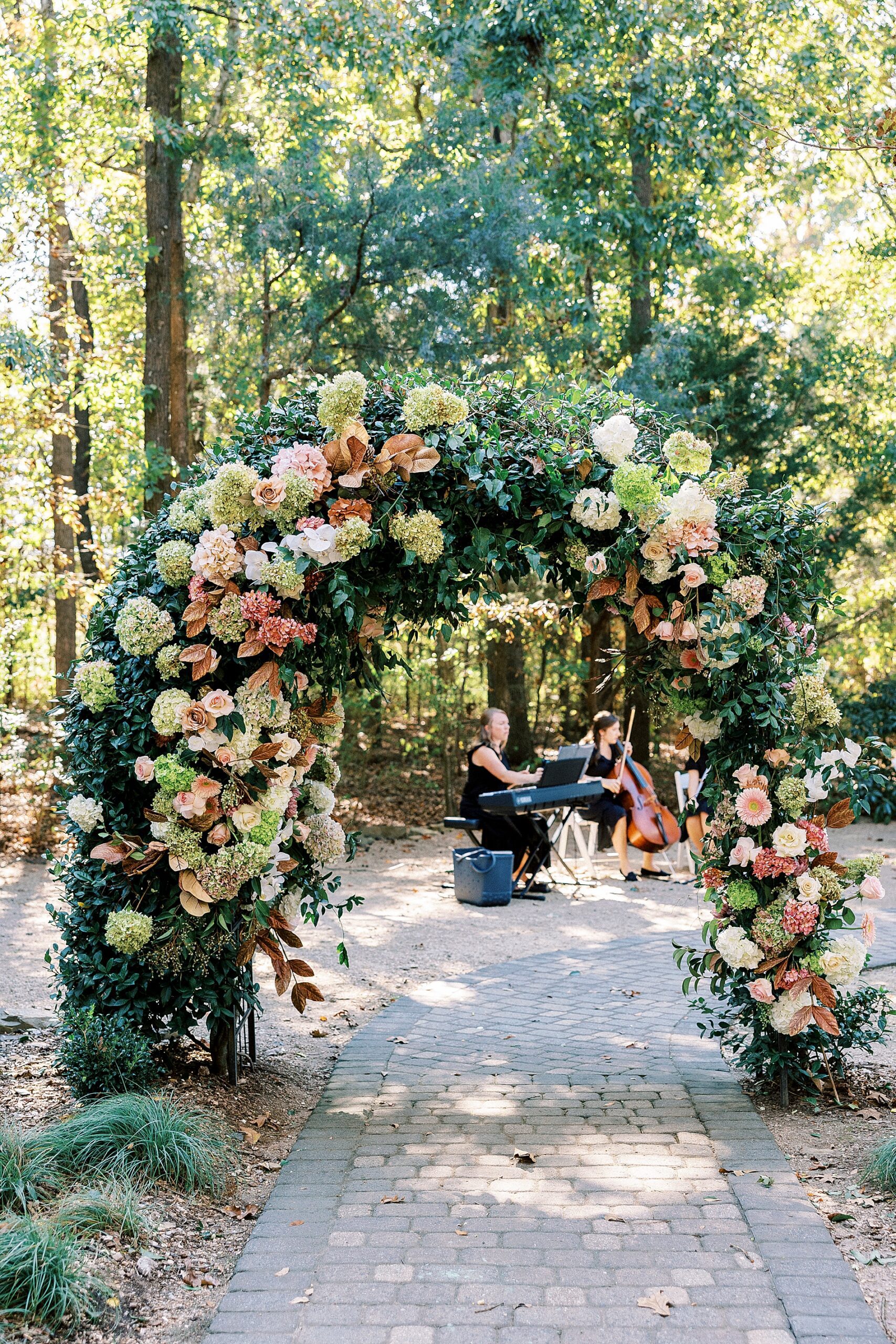 floral arch at outdoor wedding ceremony 
