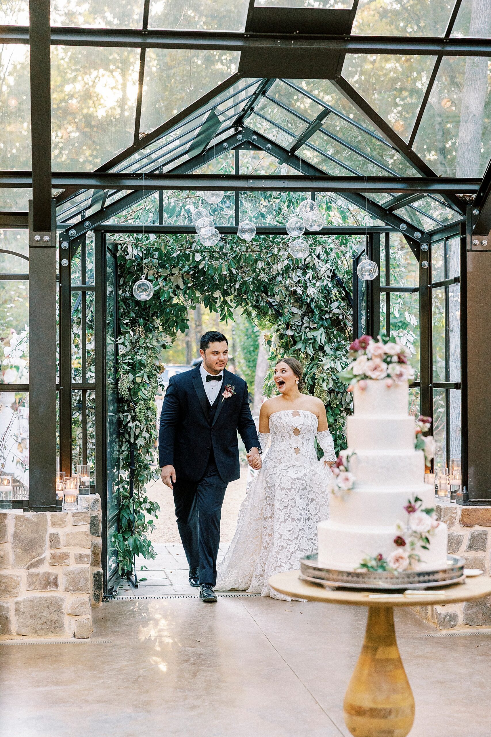 bride and groom walk through wedding reception for grand entrance 