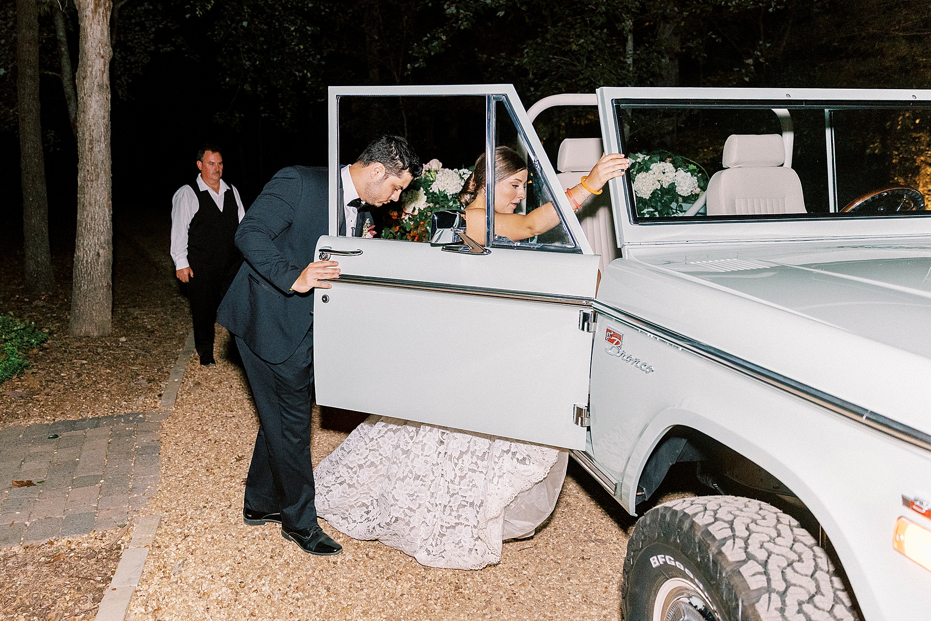 bride and groom get into vintage bronco 