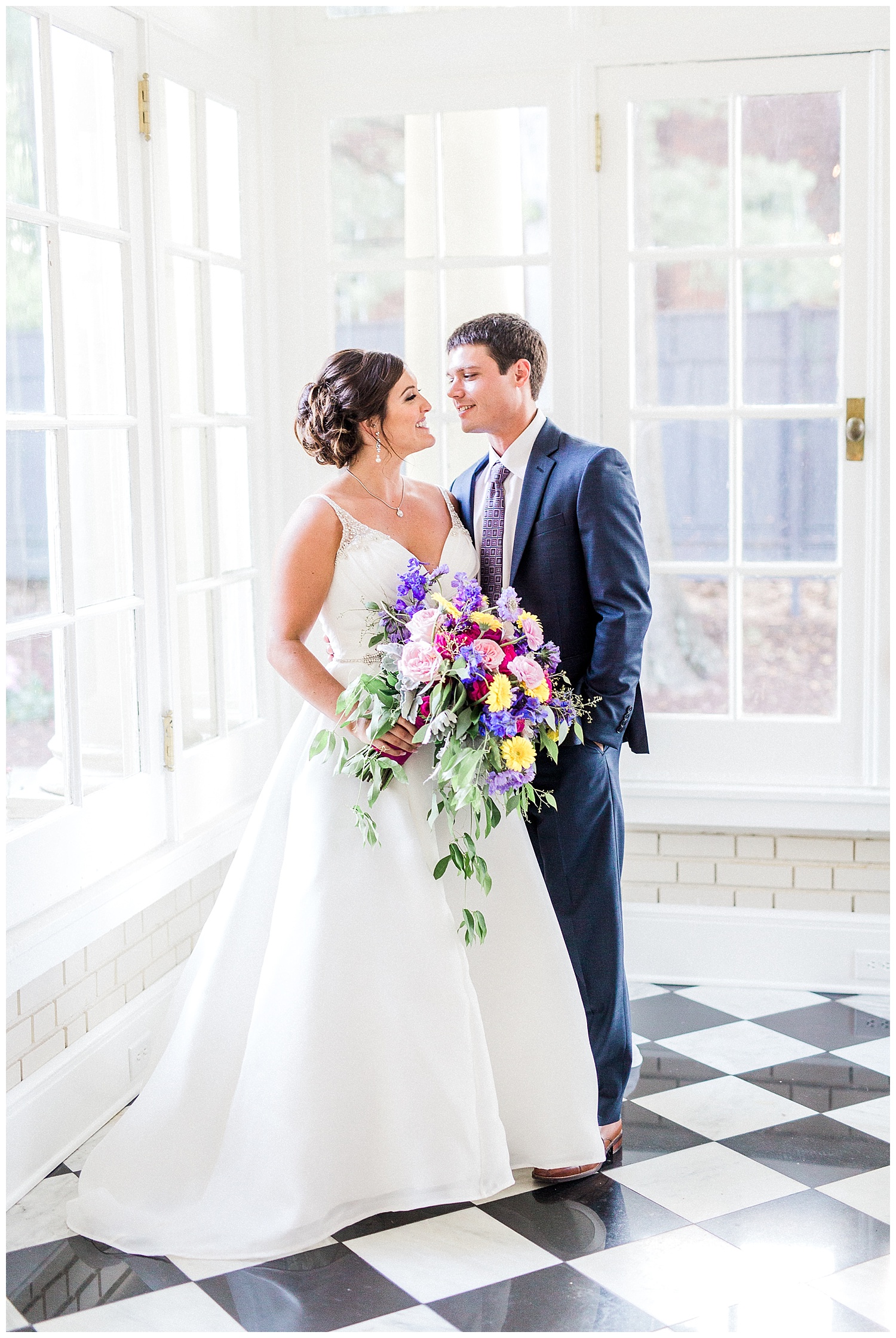 bride and groom wedding day at separk mansion in gastonia black and white tile sunroom colorful flowers
