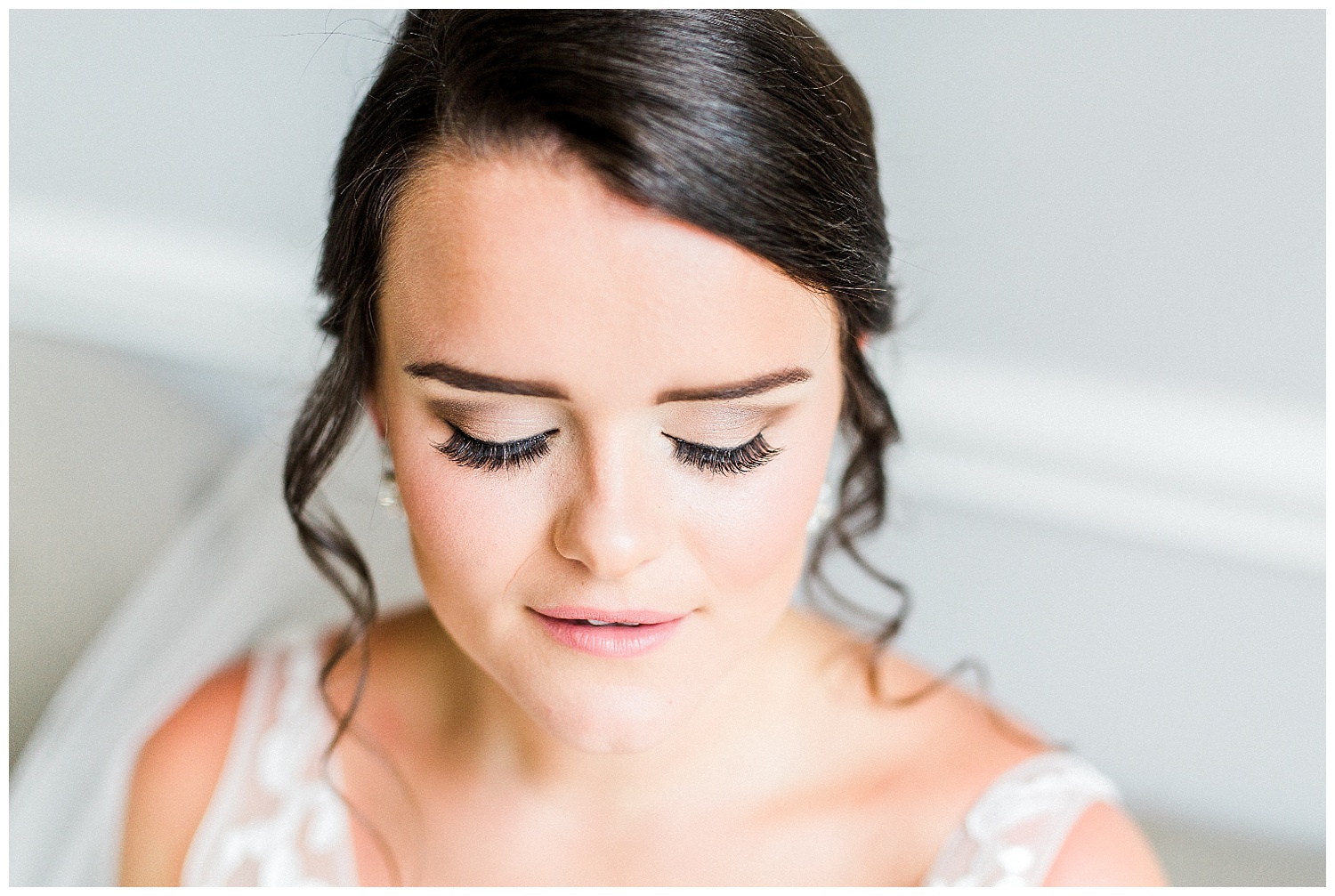 bride looking down with styled natural makeup and long eyelashes at elegant wedding venue separk mansion