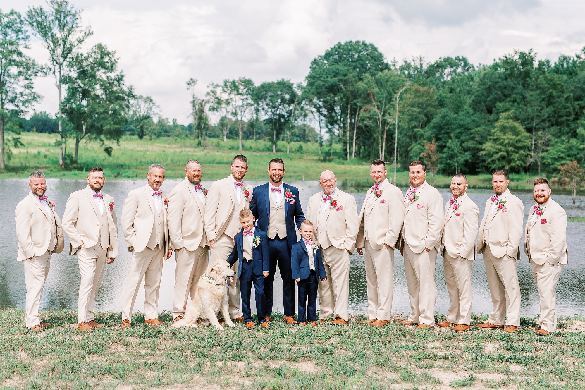 groom poses with groomsmen and ring bearers