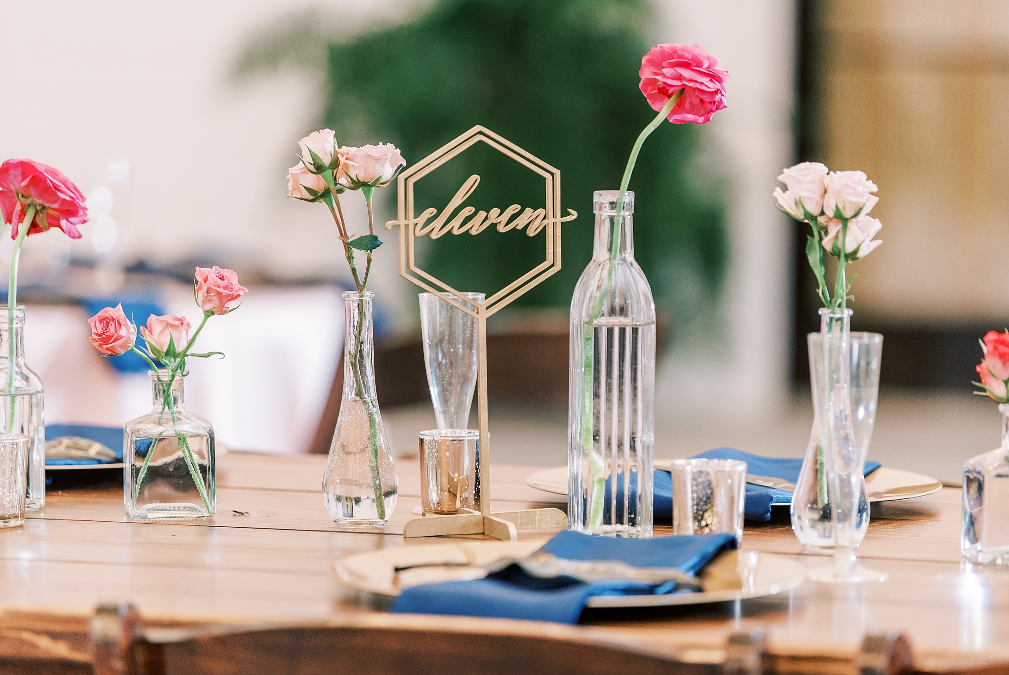 modern wedding reception details with gold and navy accents