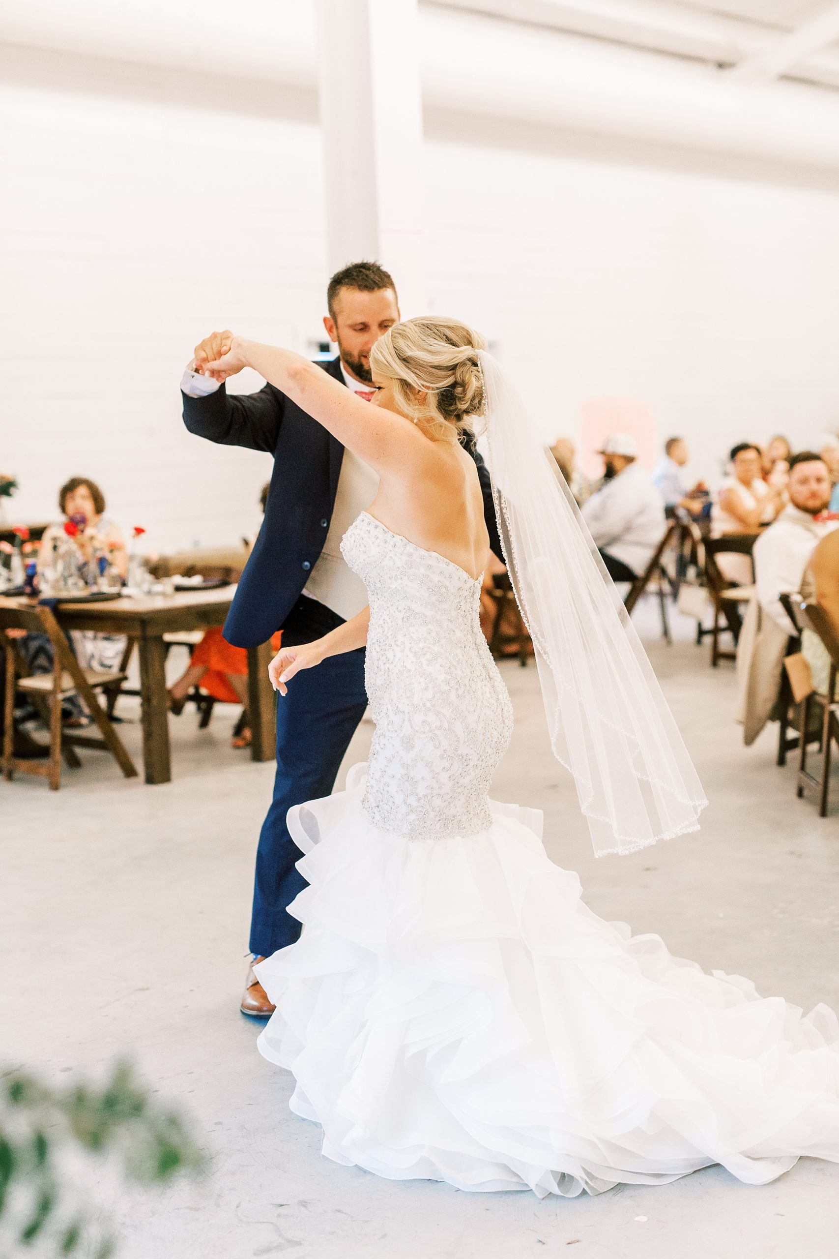 groom twirls bride while dancing