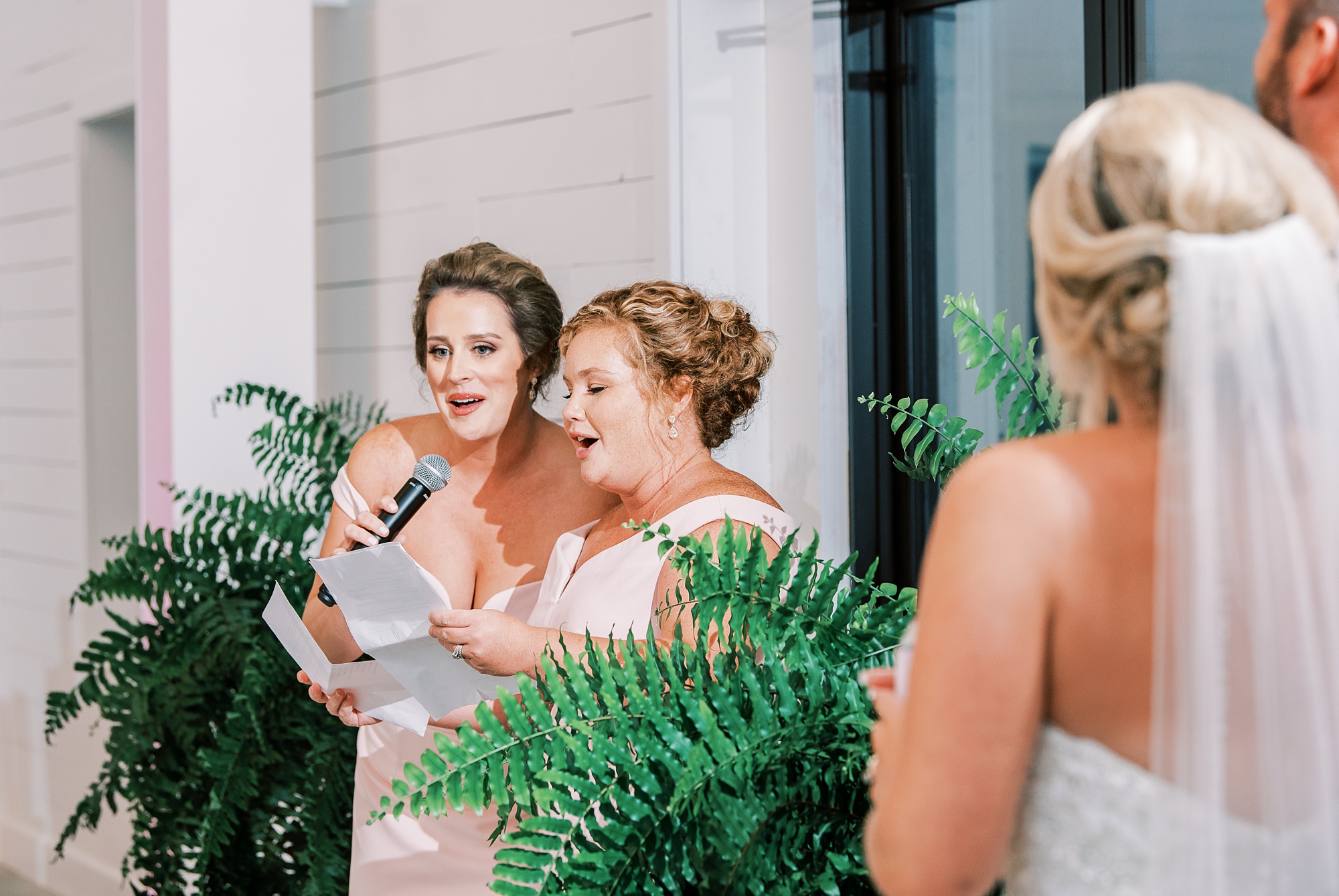 bridesmaids sing together during wedding reception