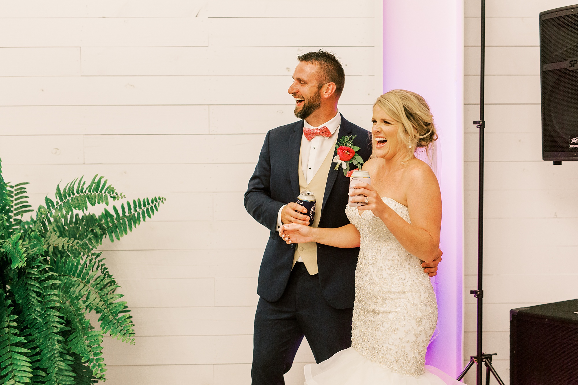 newlyweds react to wedding toasts during wedding reception