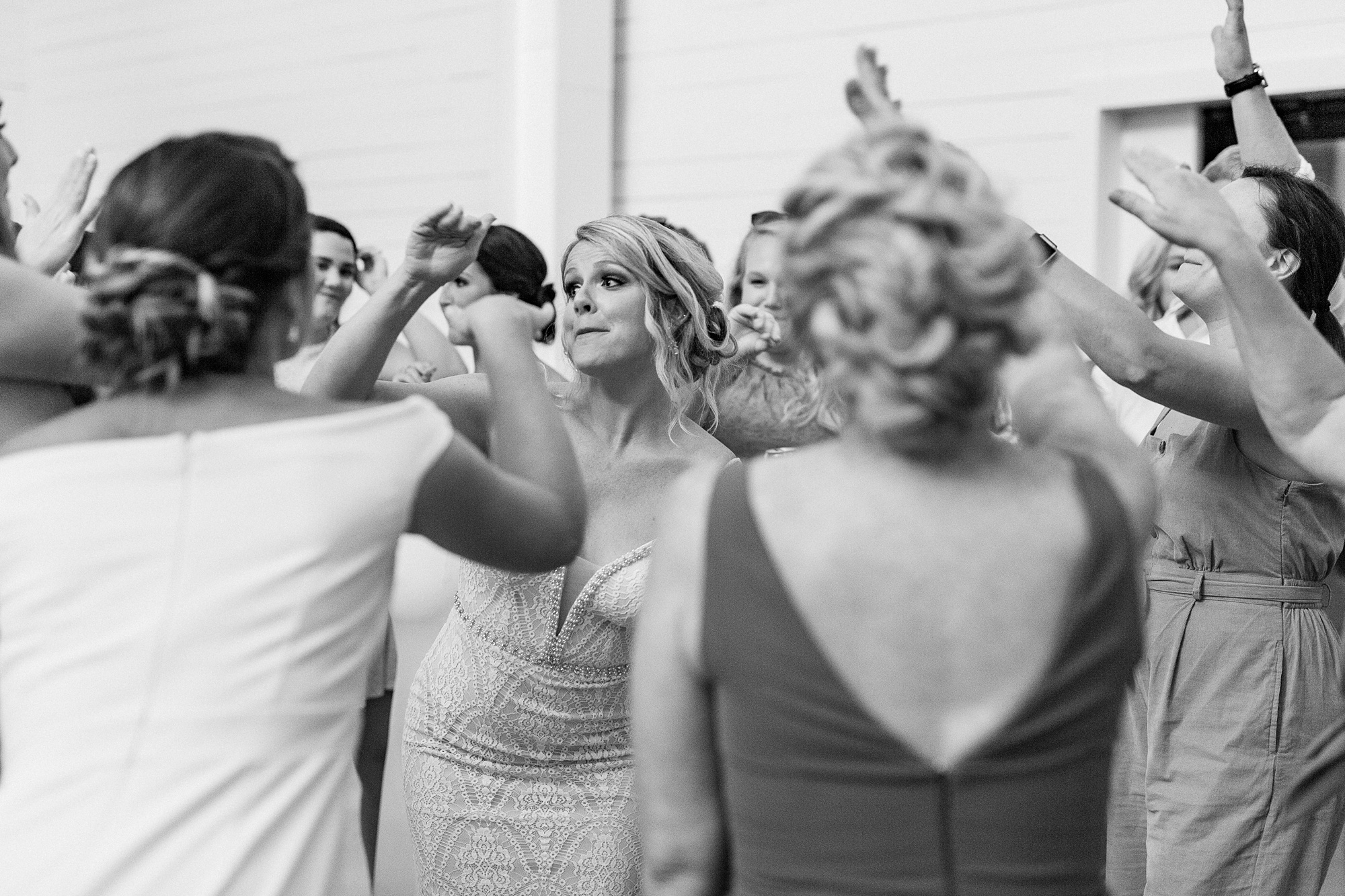 bride dances with guests during wedding reception