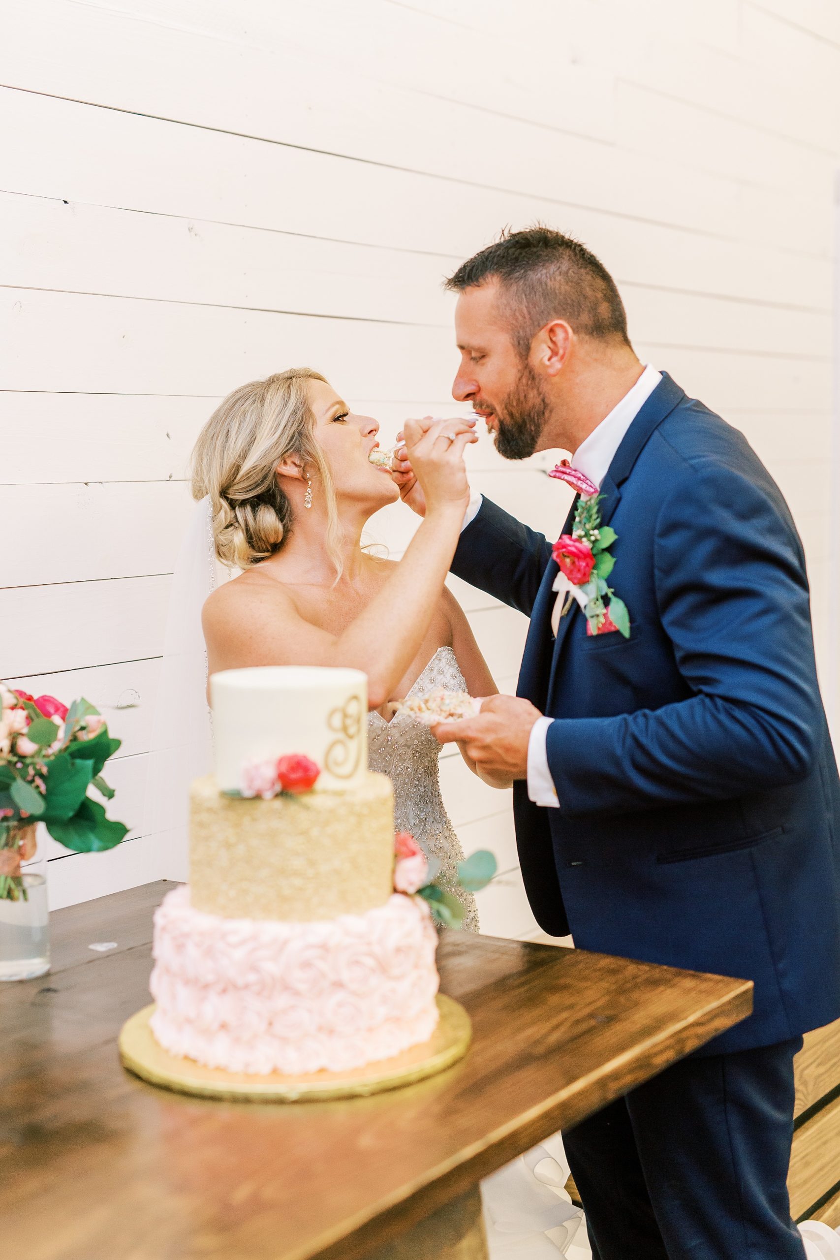 bride and groom eat wedding cake during SC wedding reception