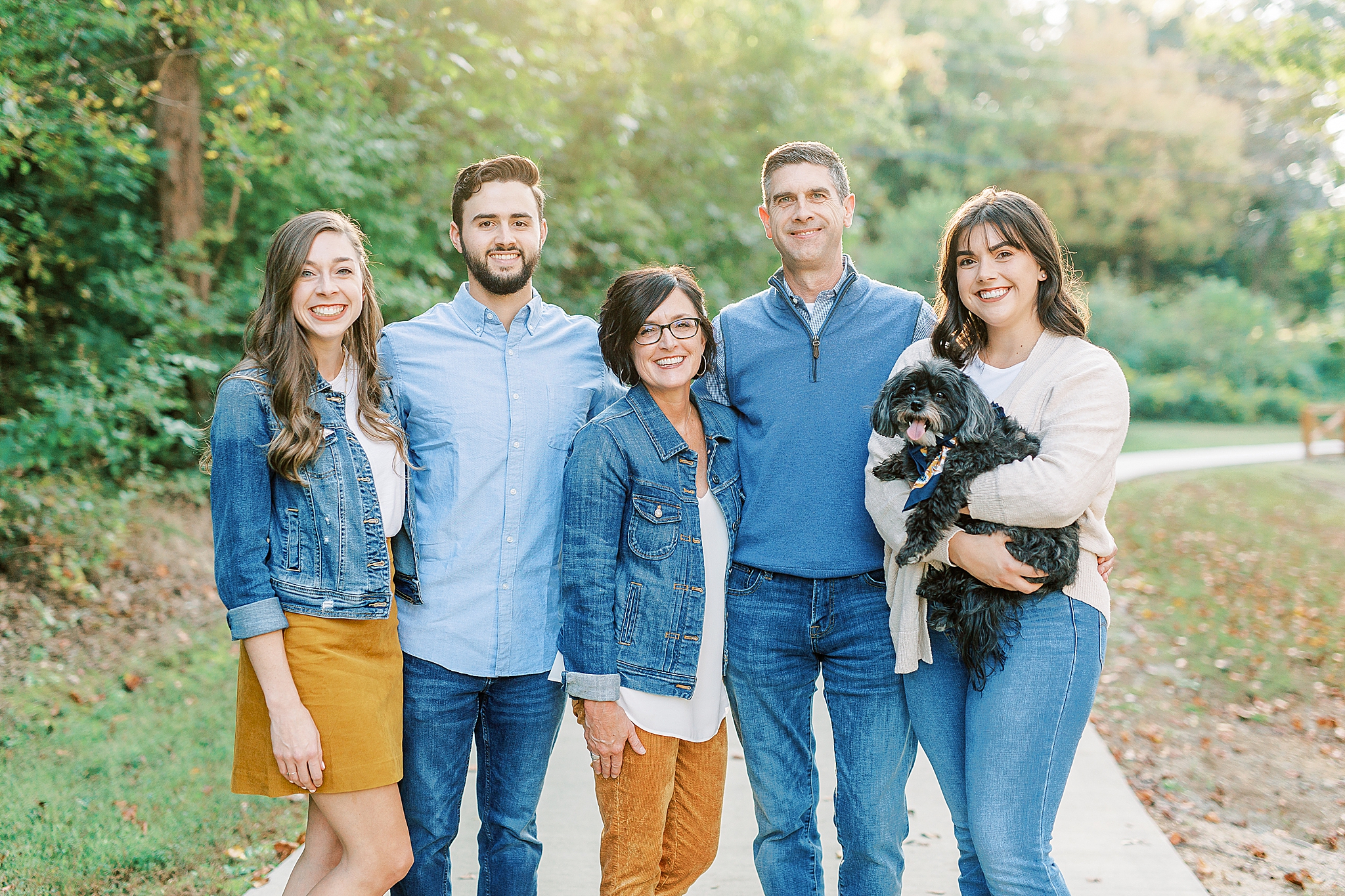 family of five poses with dog