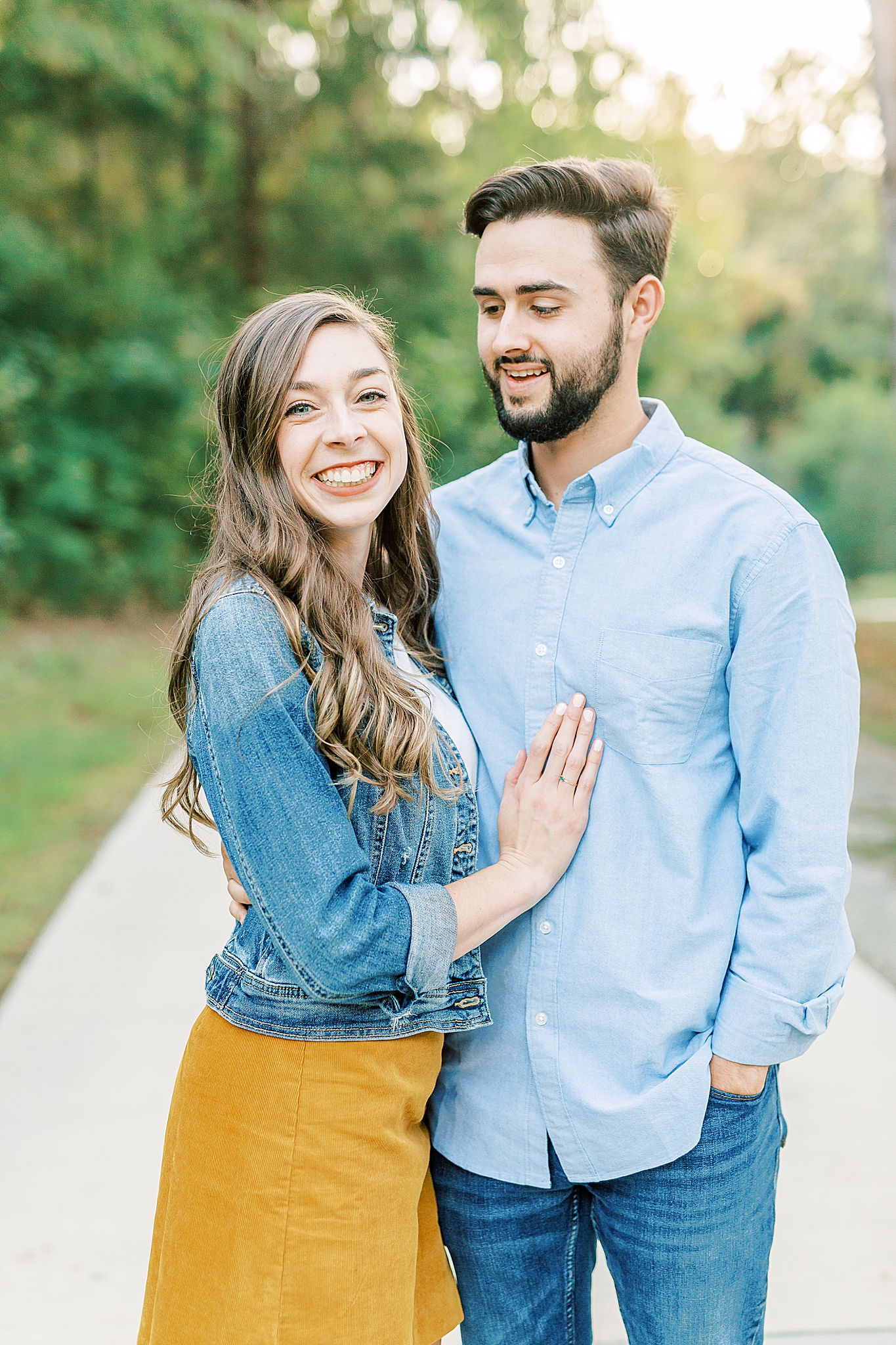 married couple laughs during NC family photos