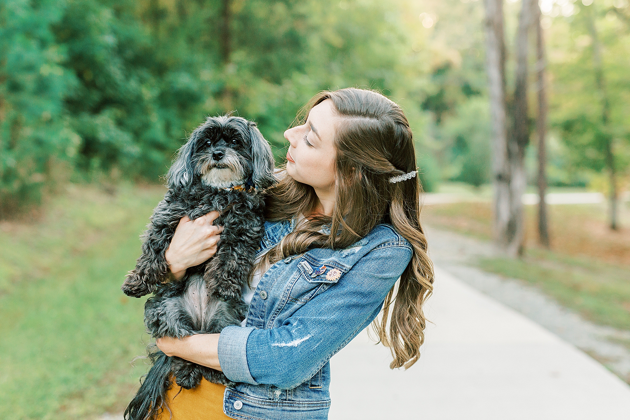daughter holds little dog during Charlotte Fall Family Portraits