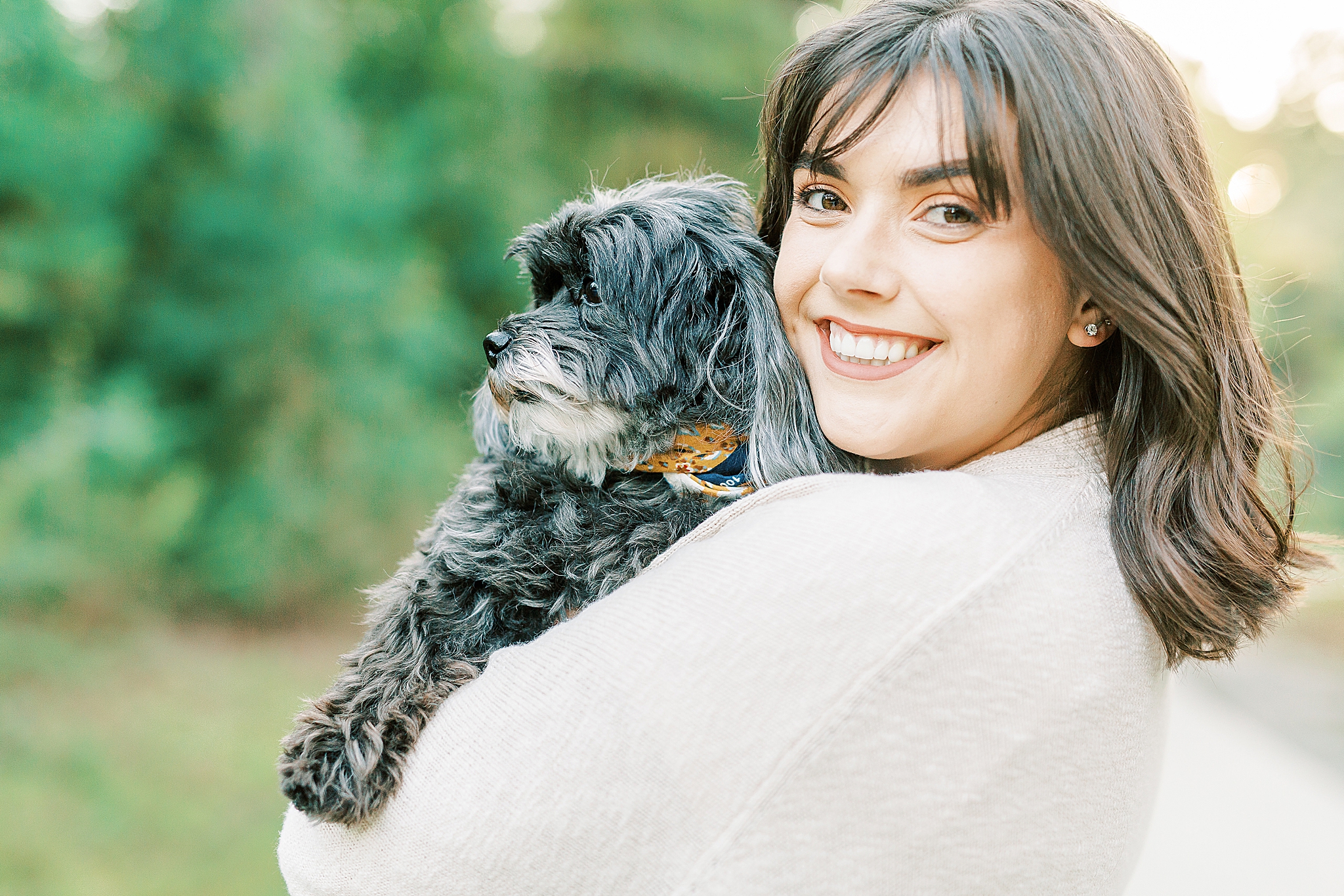 daughter holds dog during Charlotte Fall Family Portraits