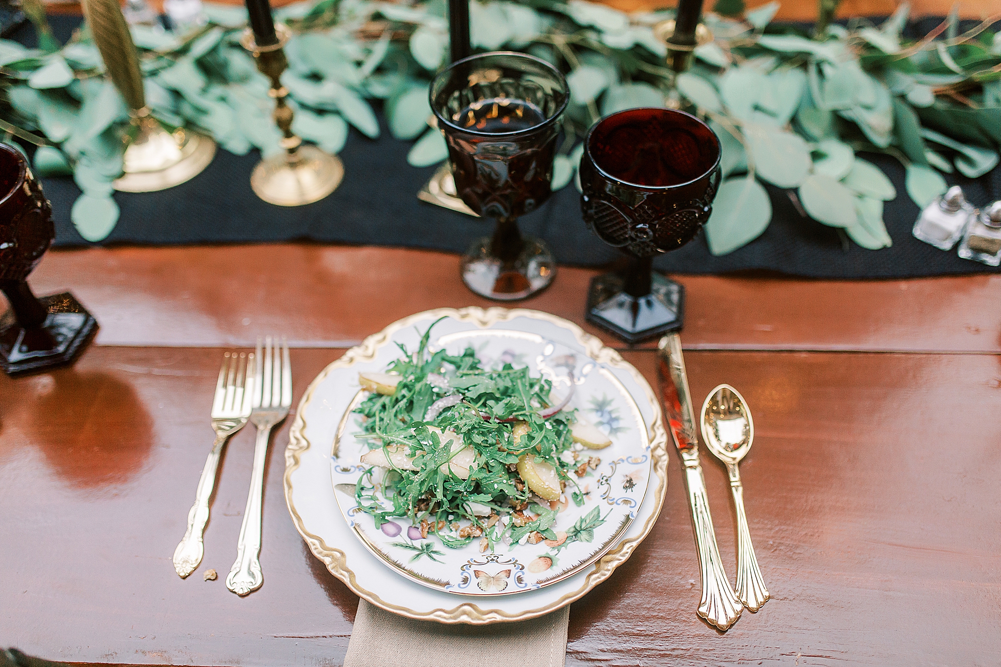 place setting with vintage china and gold silverware