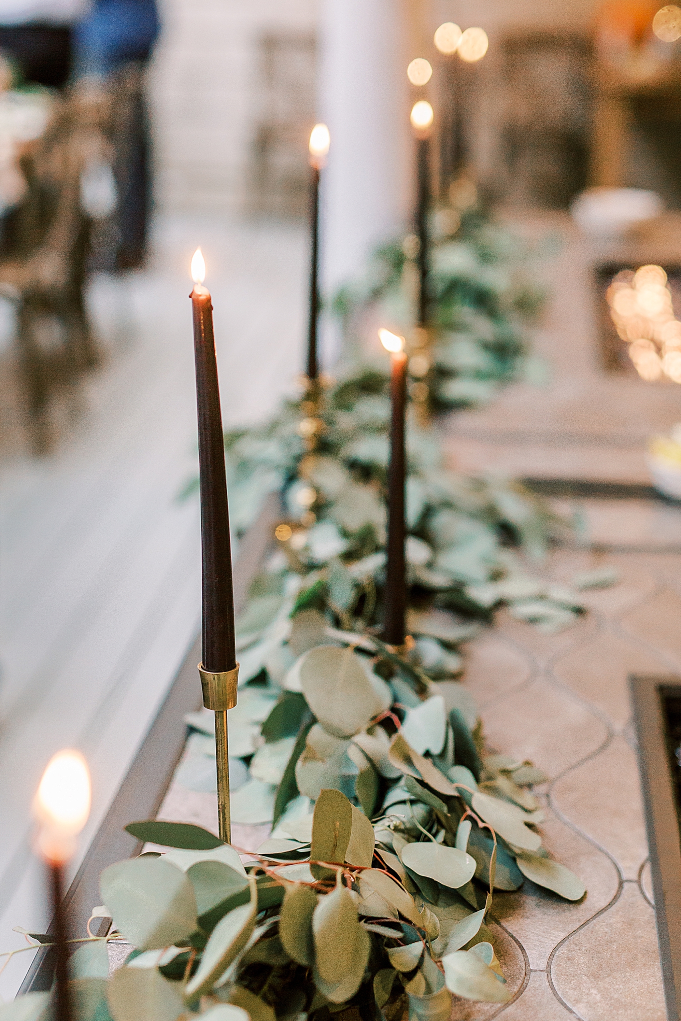 black candles in gold holders for rehearsal dinner