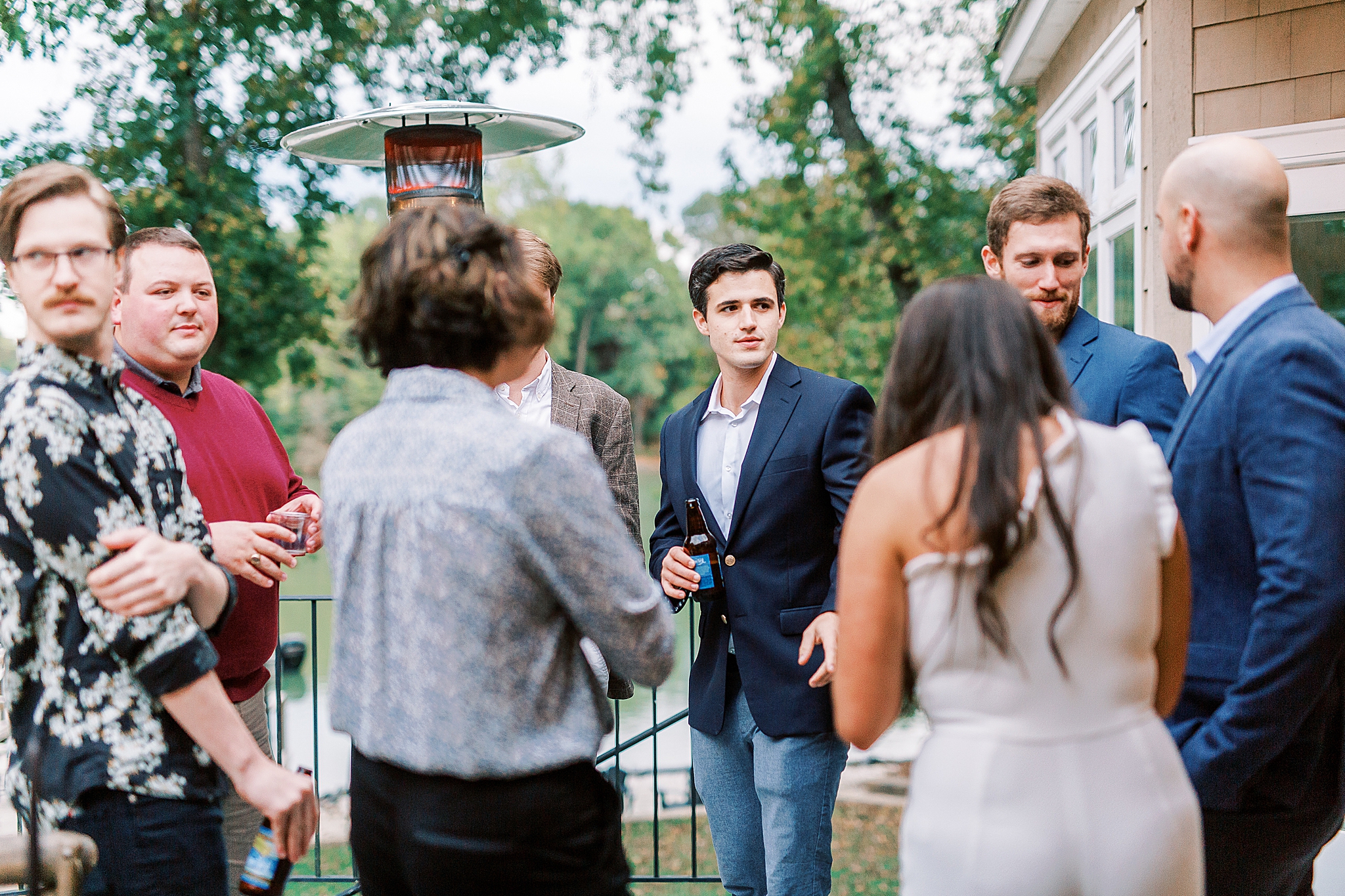 groom talks to guests during Charlotte NC Rehearsal Dinner