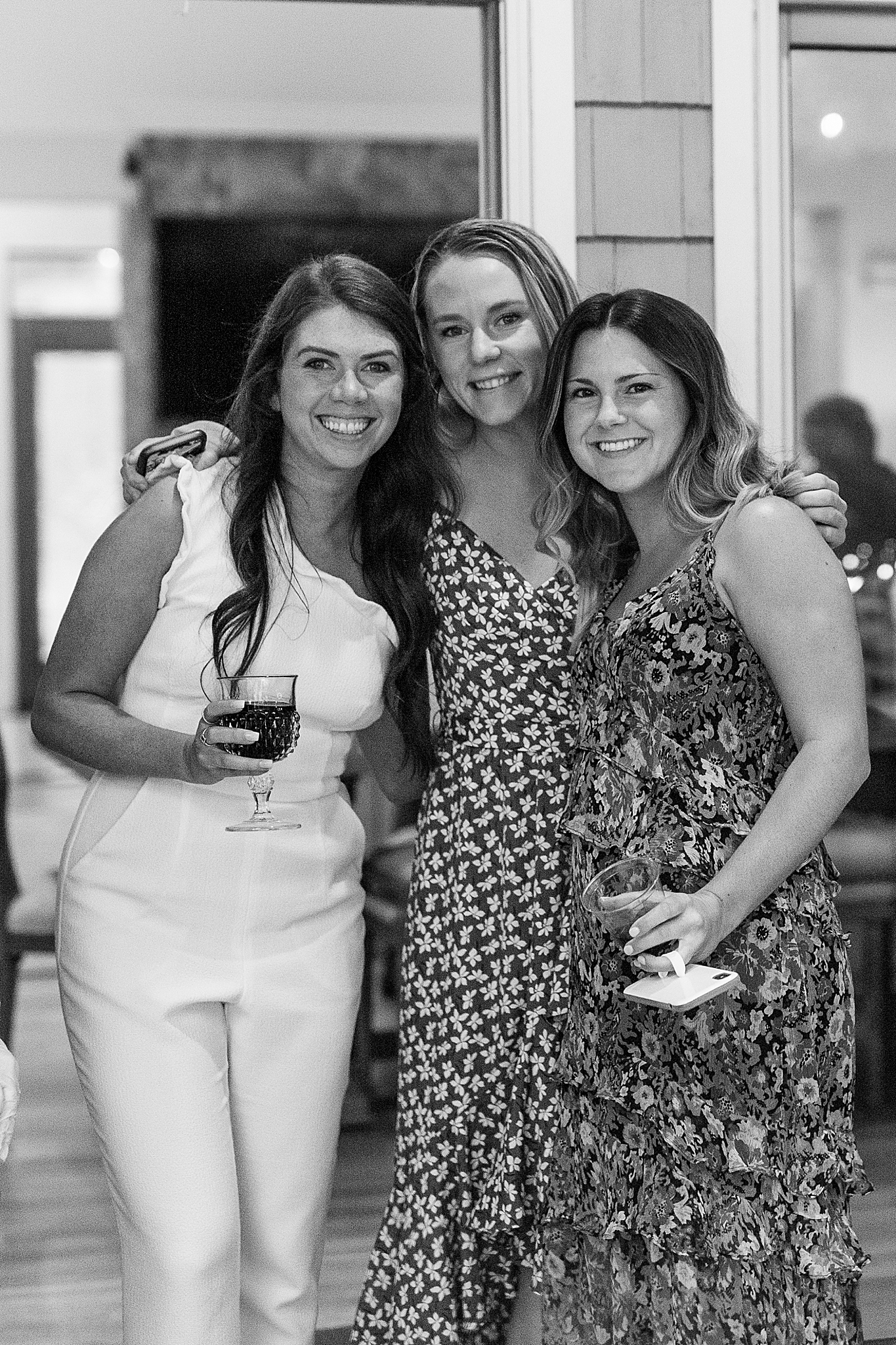 bride poses with guests at Charlotte NC Rehearsal Dinner