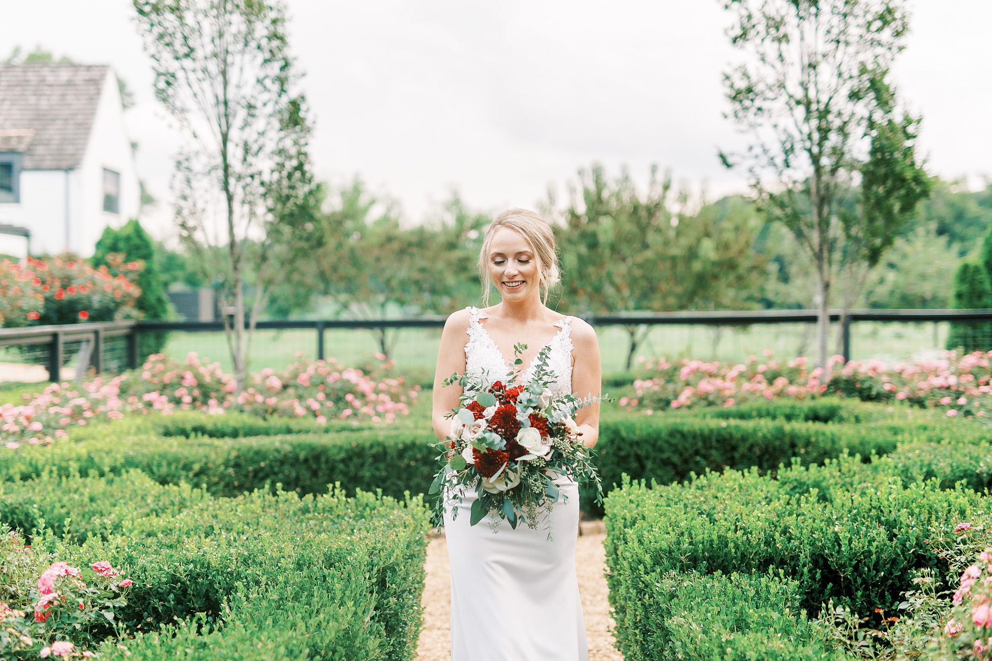 bride holds bouquet during portraits in garden