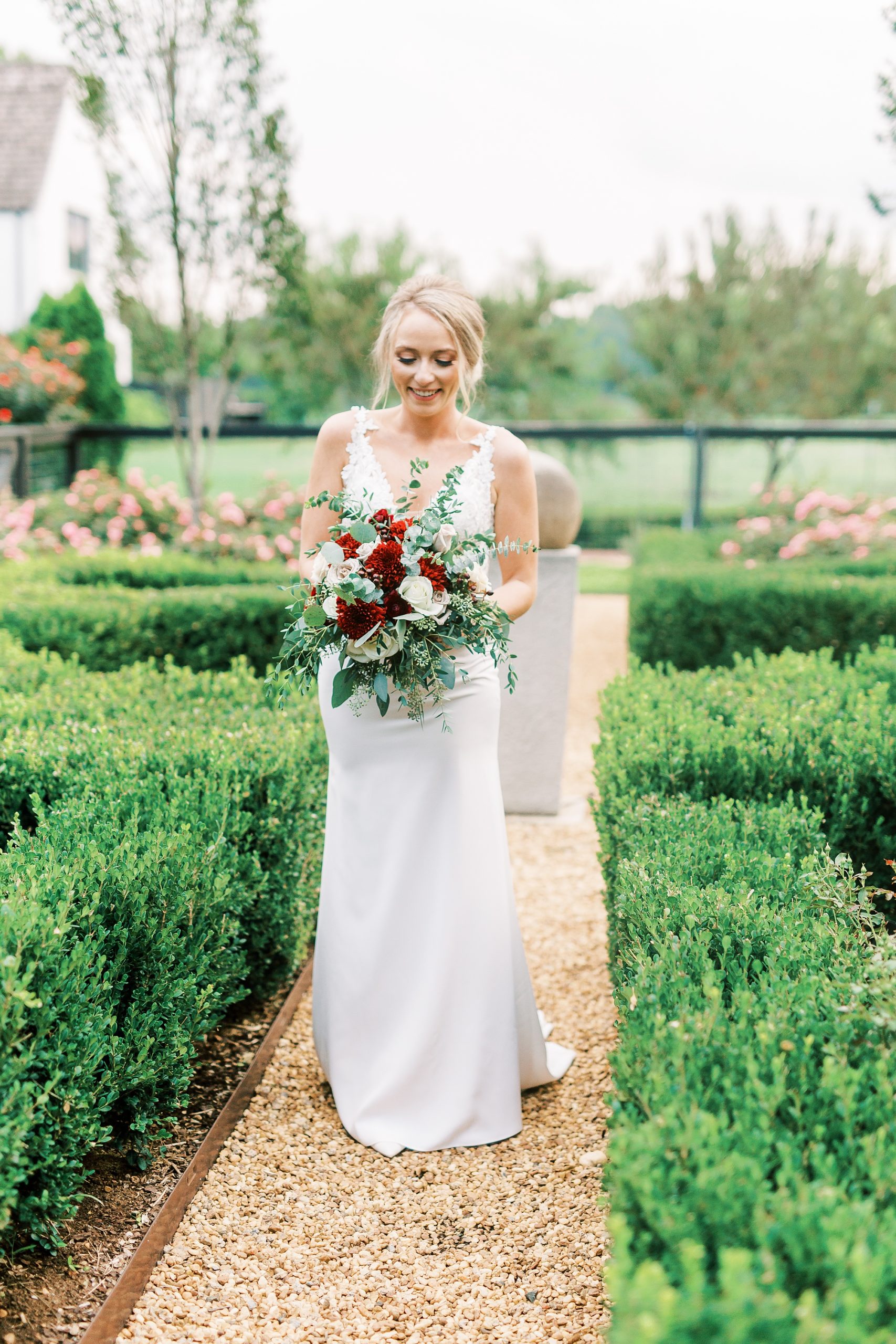 bride-to-be walks through gardens at The Andrews Farm