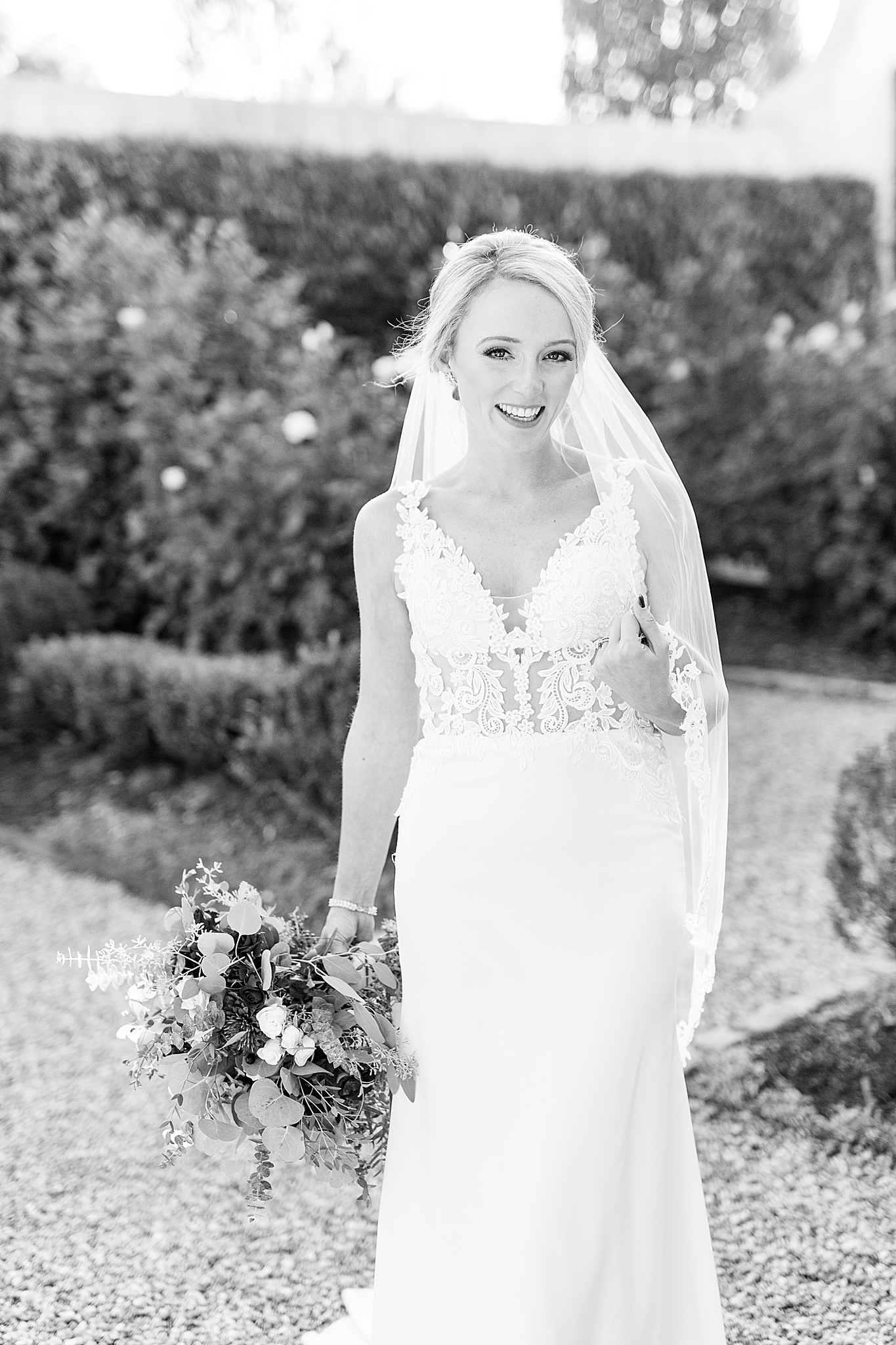 bride smiles during portraits in gardens