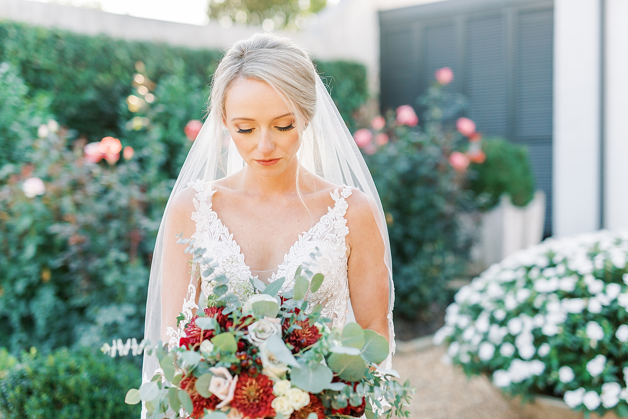 bride looks at flowers during NC wedding day