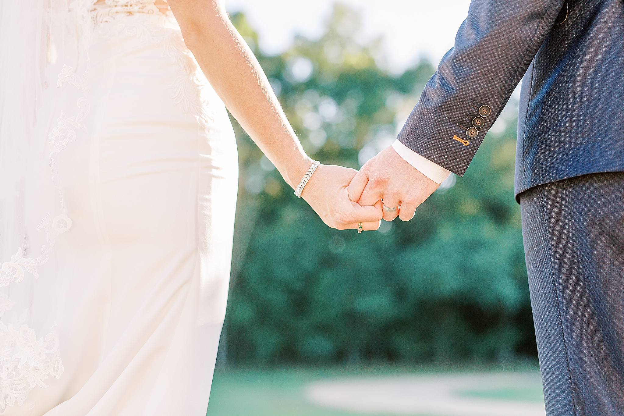 bride and groom hold hands during NC wedding photos