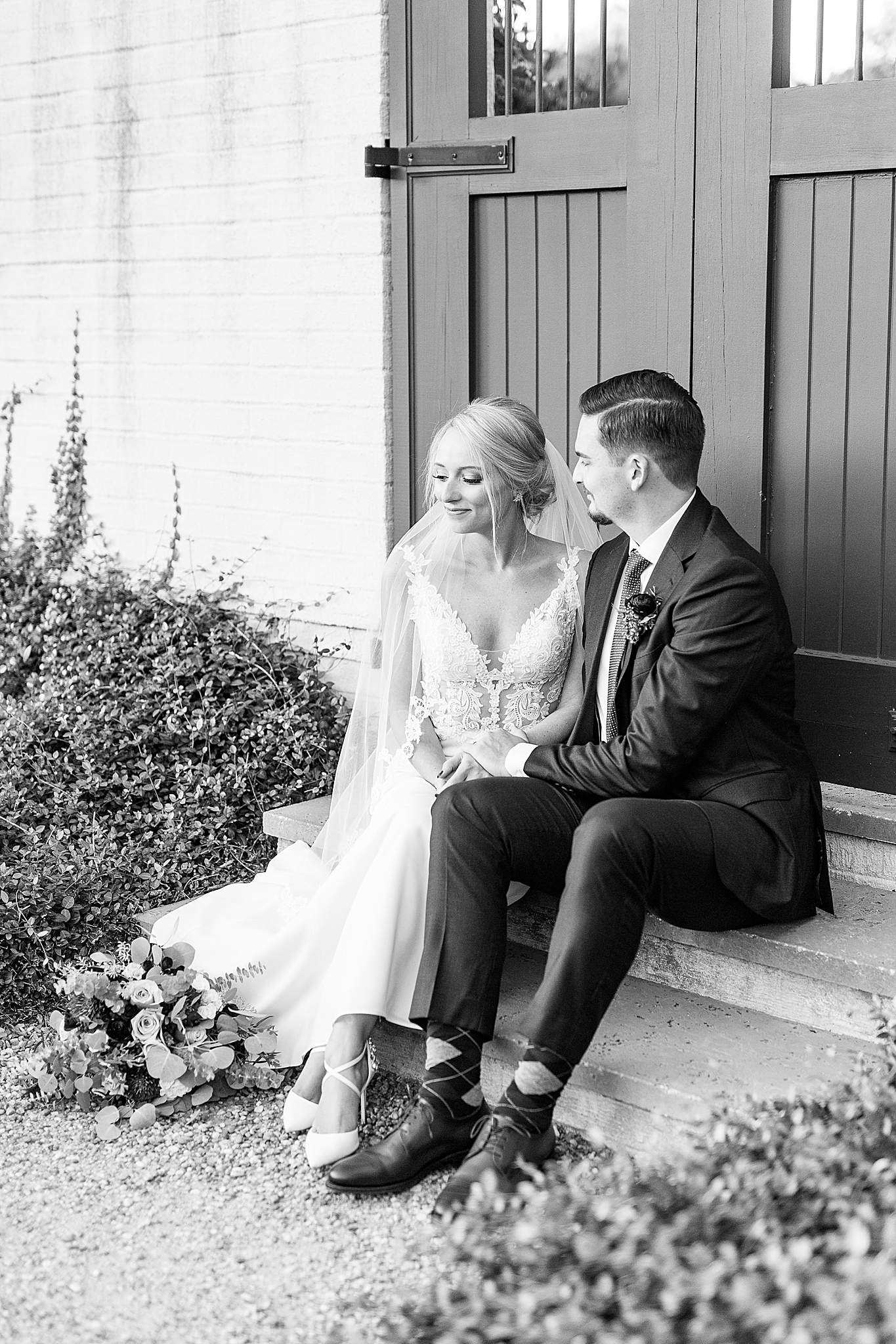 bride and groom sit on steps after Andrews Farm Elopement