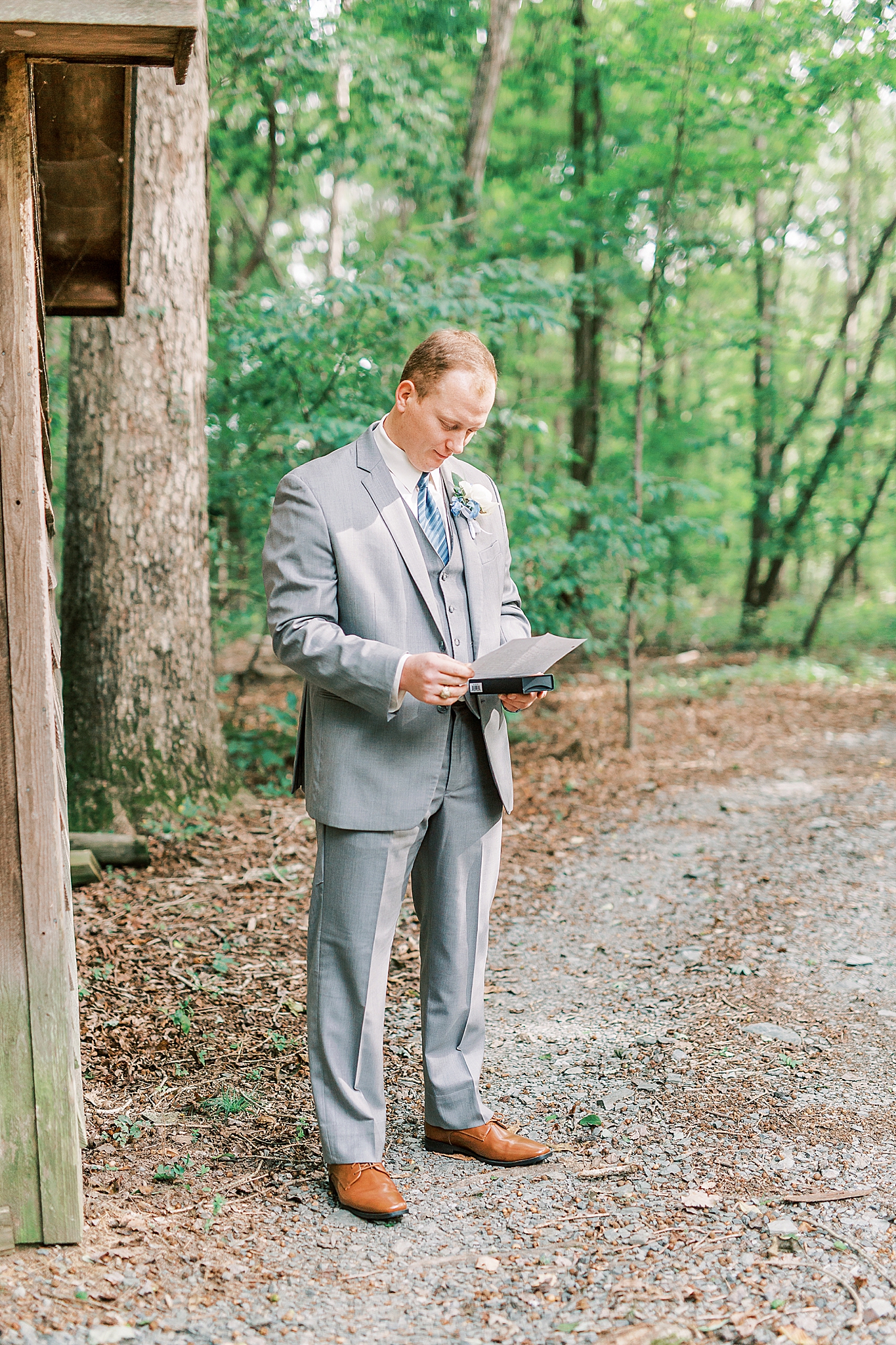 groom opens gift from bride before NC wedding