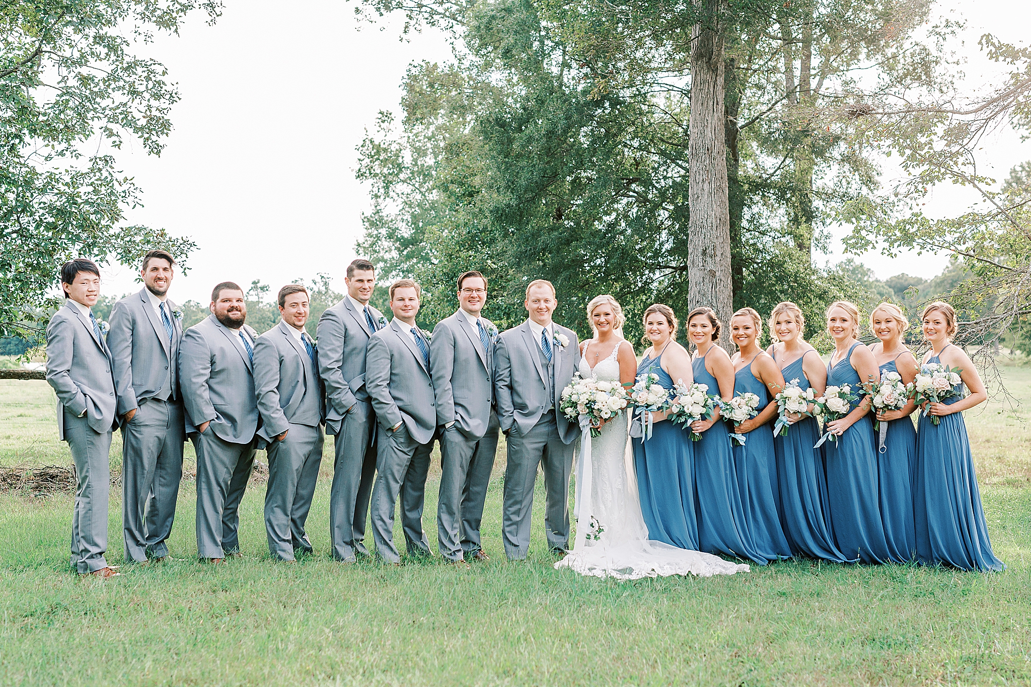 wedding party in blue and grey poses at The Farm at Brusharbor
