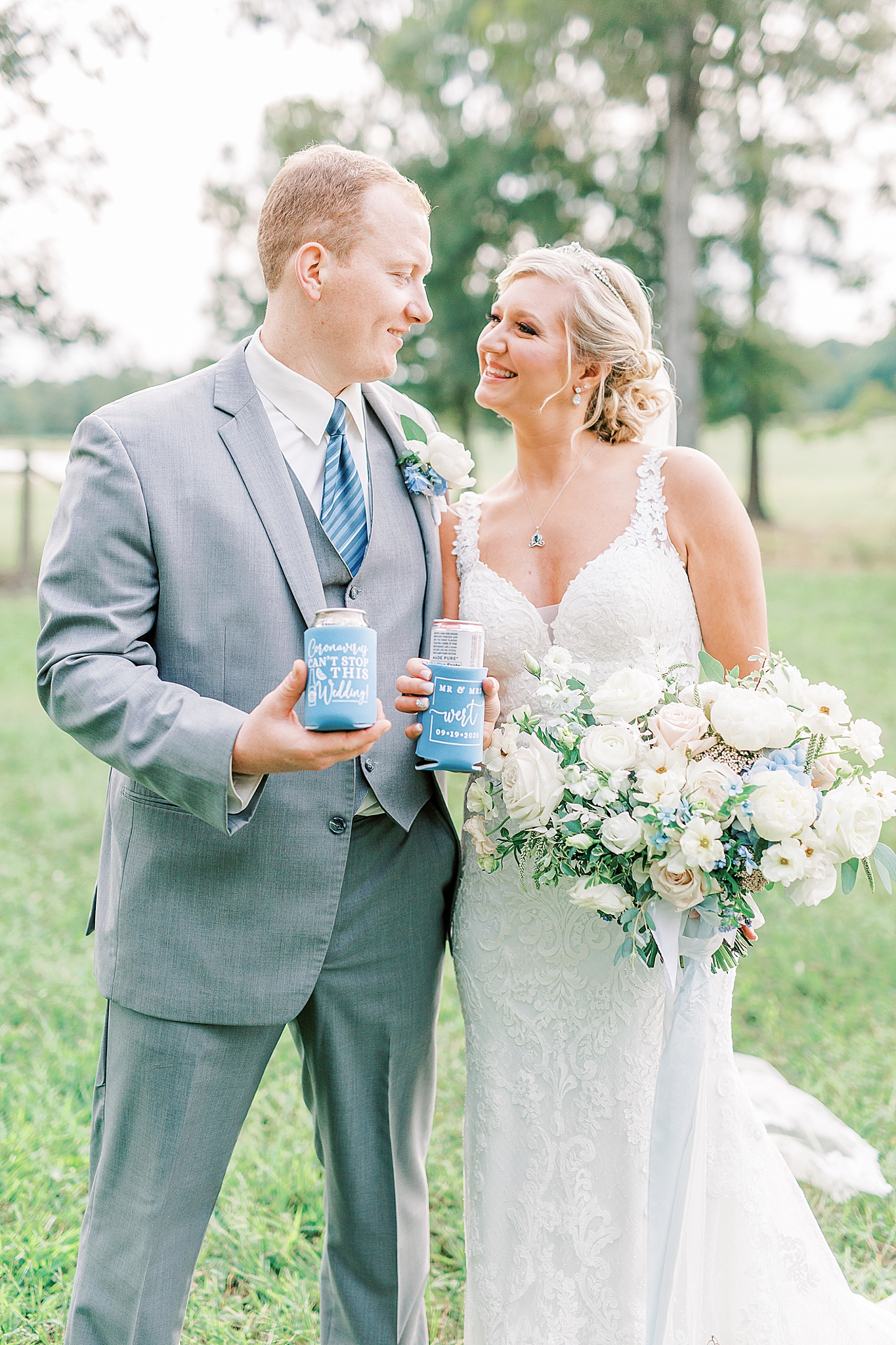 bride and groom pose with custom koozies and beer during COVID-19 wedding