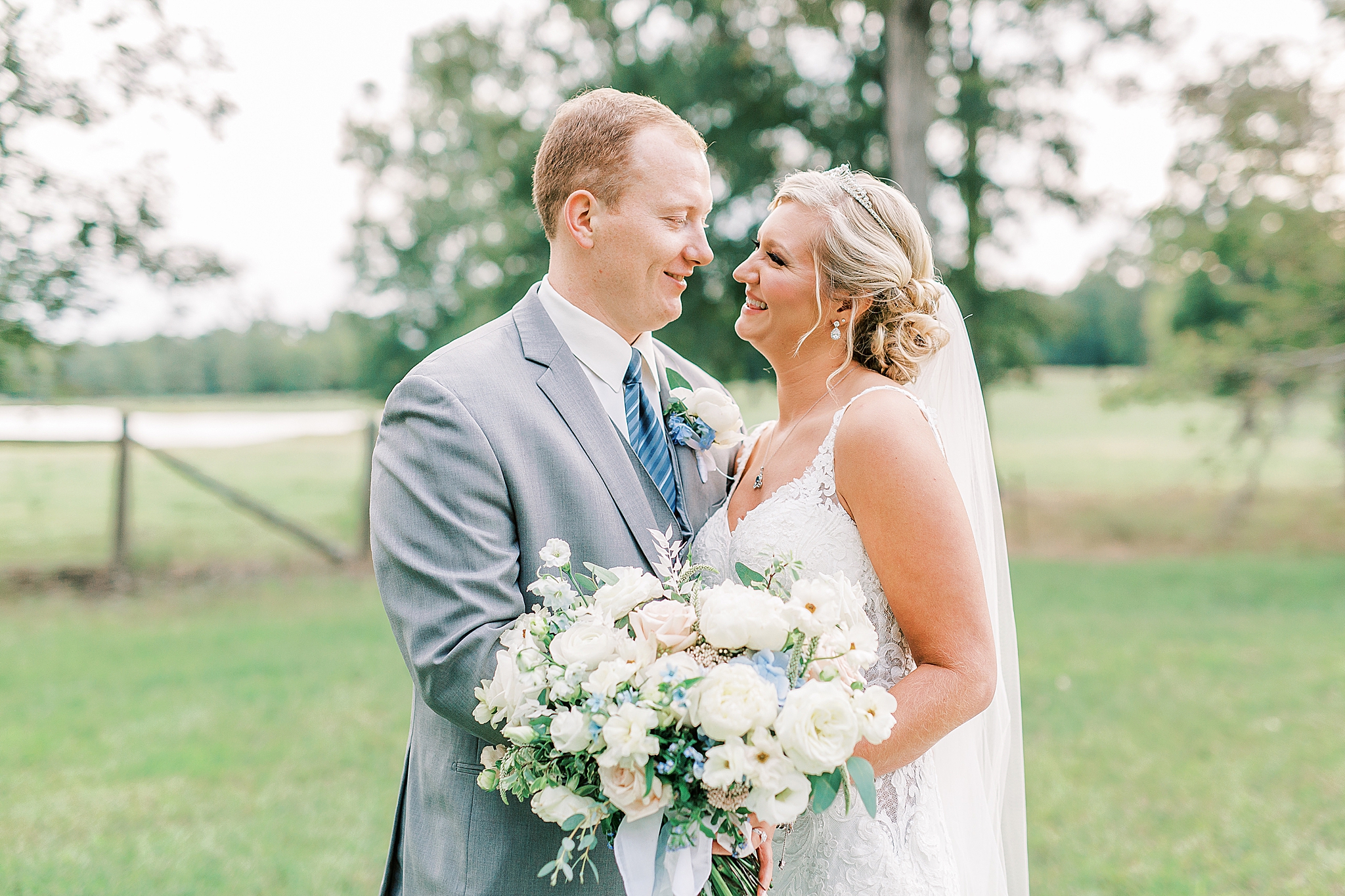 bride and groom laugh while standing together in NC