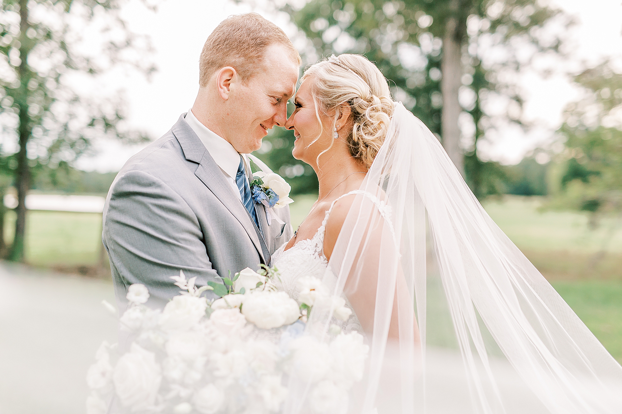 bride and groom stand touching noses during NC wedding photos