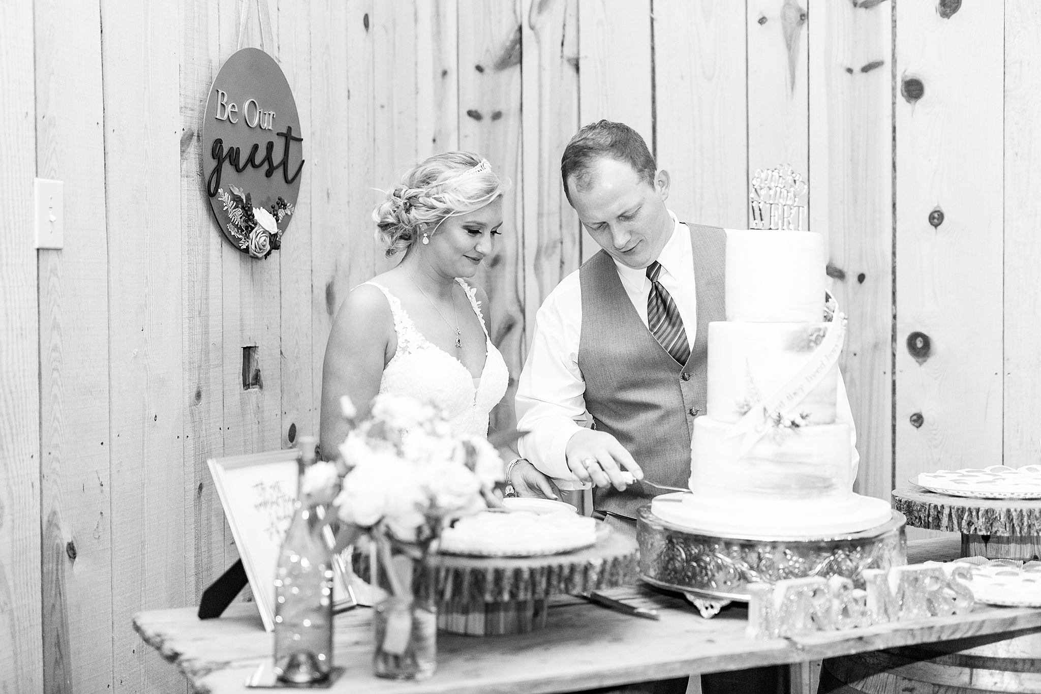 newlyweds cut wedding cake at The Farm at Brusharbor wedding reception