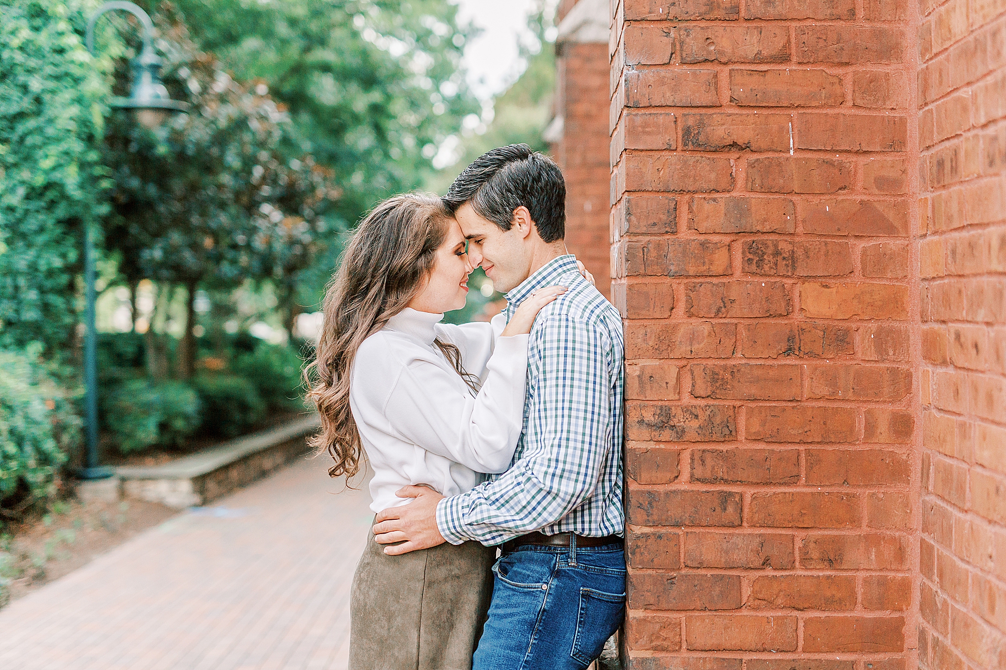 engaged couple stands touching foreheads during NC engagement photos