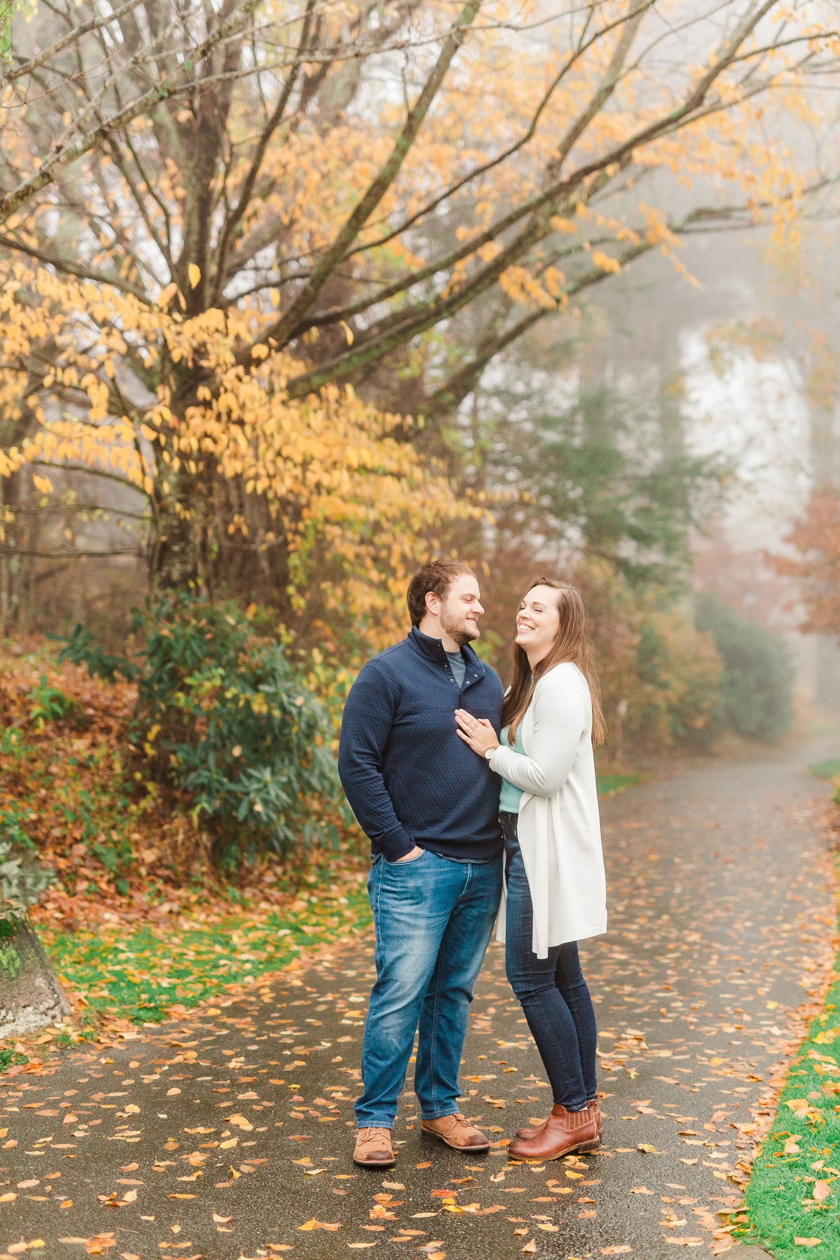 bride and groom pose on path during Blowing Rock engagement photos