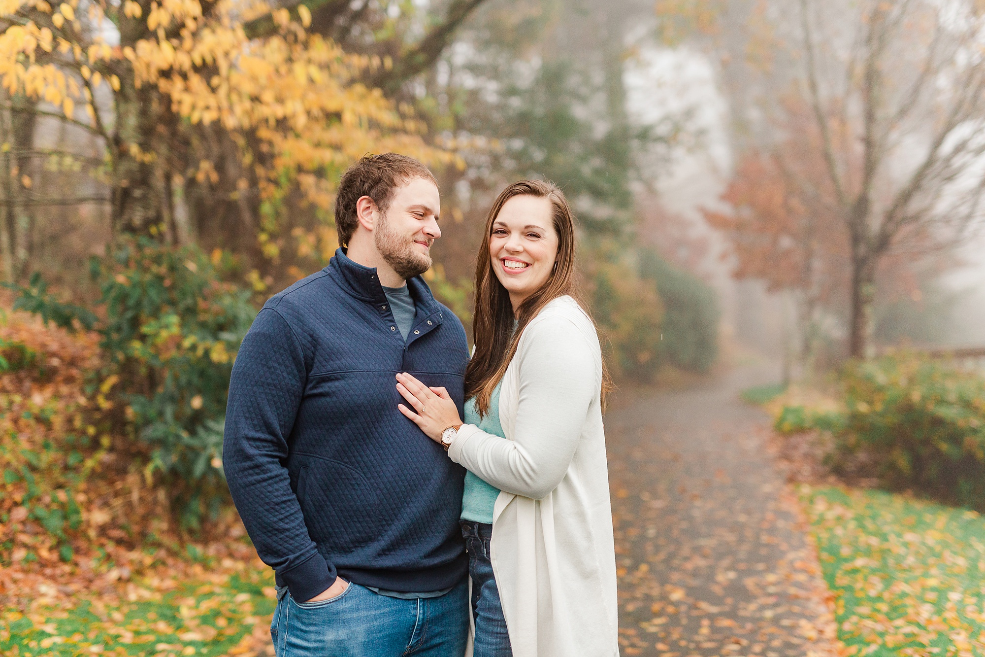 bride and groom pose during fall engagement photos