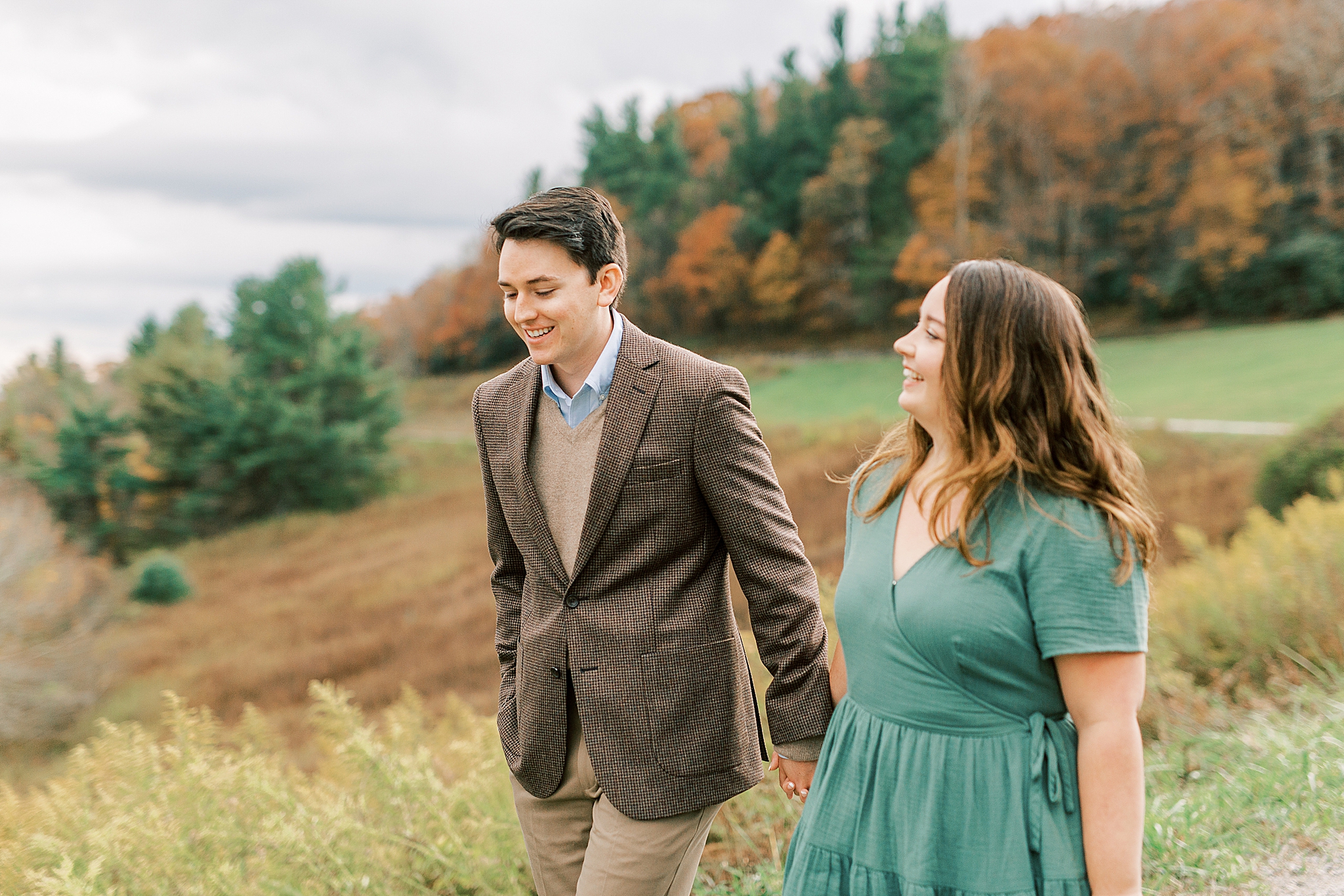 couple walks through fall foliage at Boone NC manor
