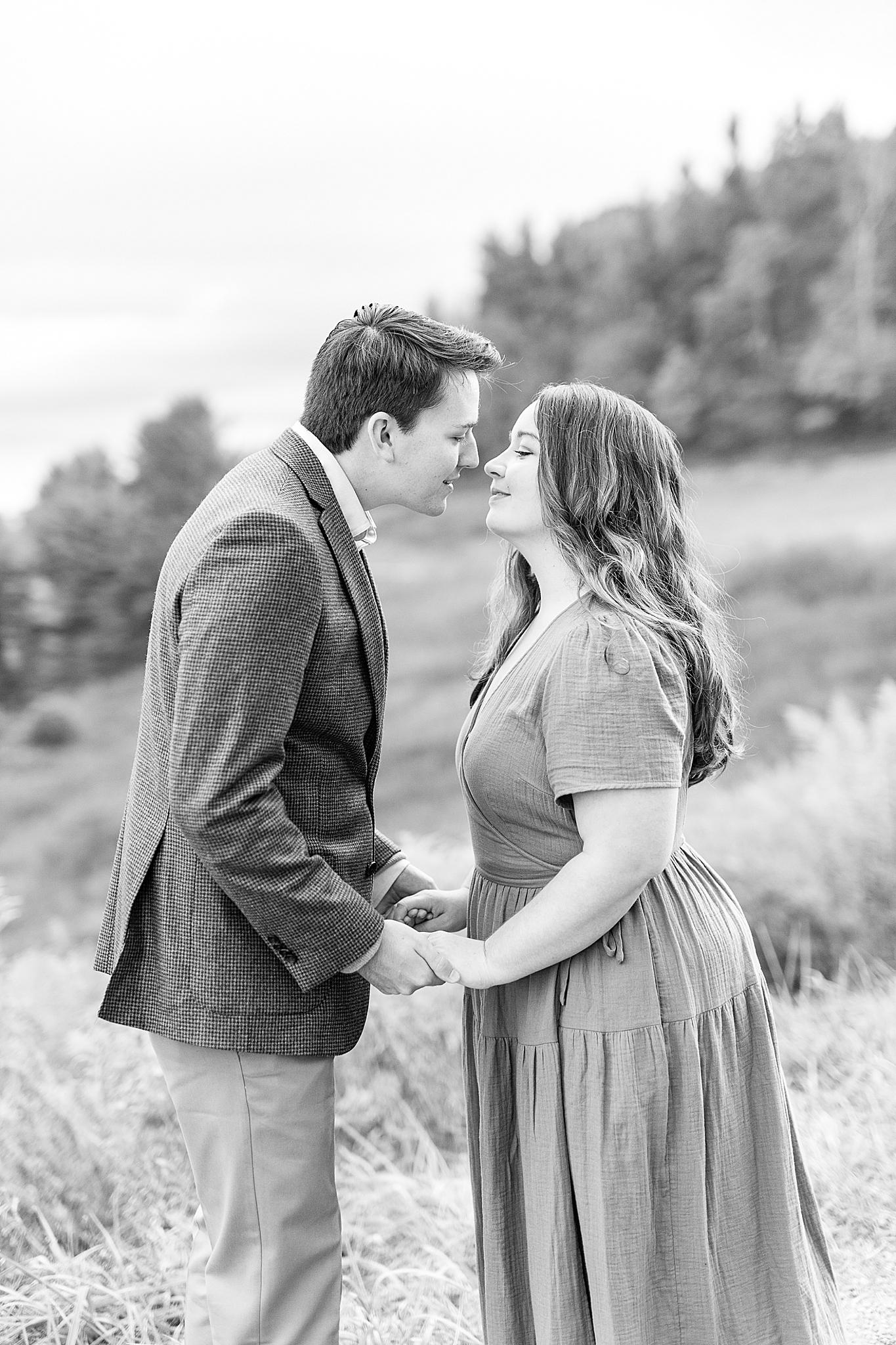 couple leans in to kiss during NC engagement photos
