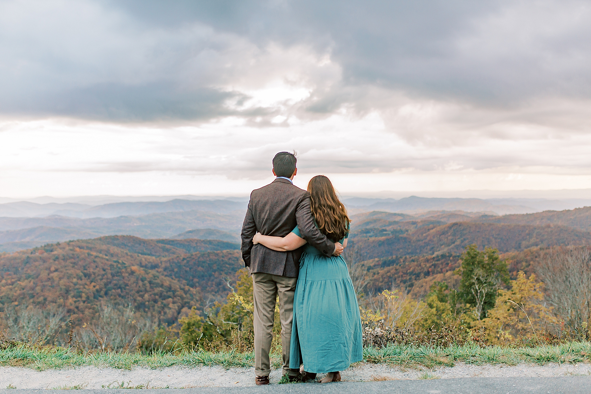 bride and groom look at mountains during NC engagement photos