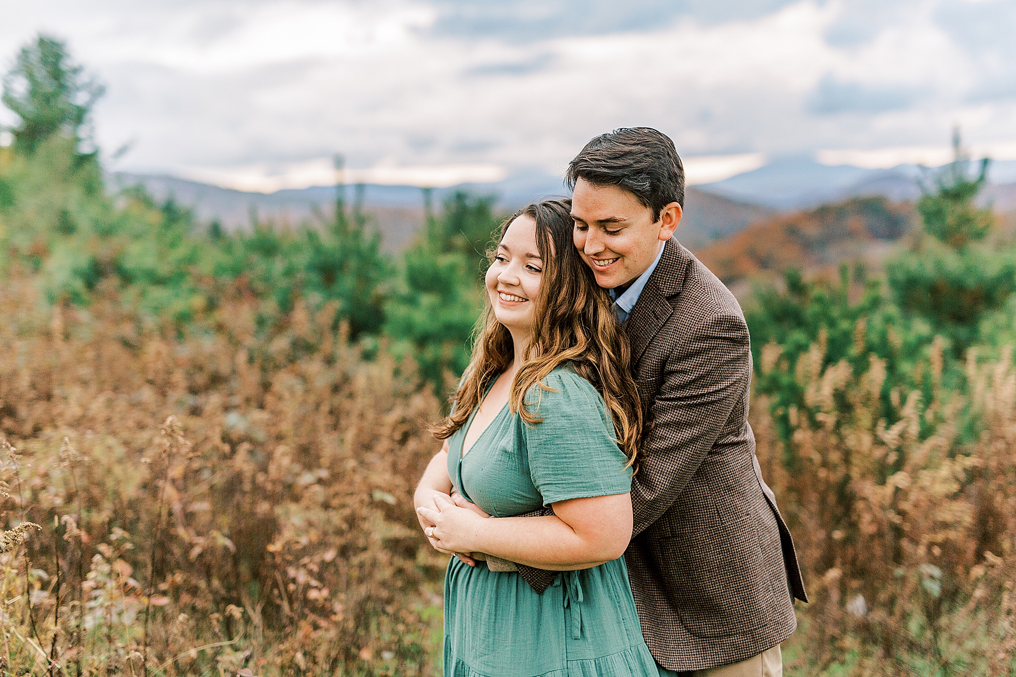 groom hugs bride from behind during NC engagement photos