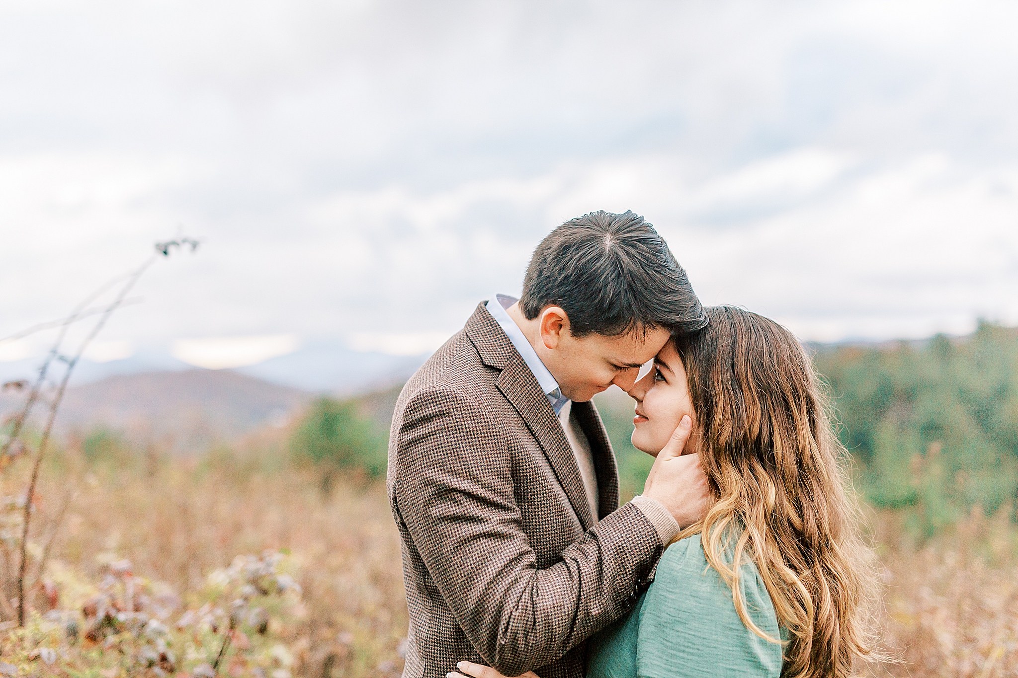 fall engagement portraits of bride and groom in front of mountains