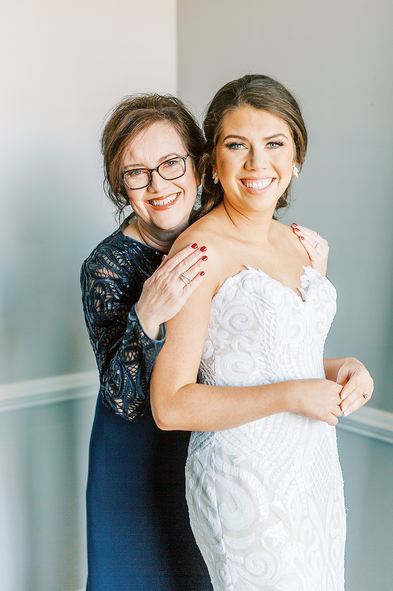mom hugs bride after preparing for NC wedding