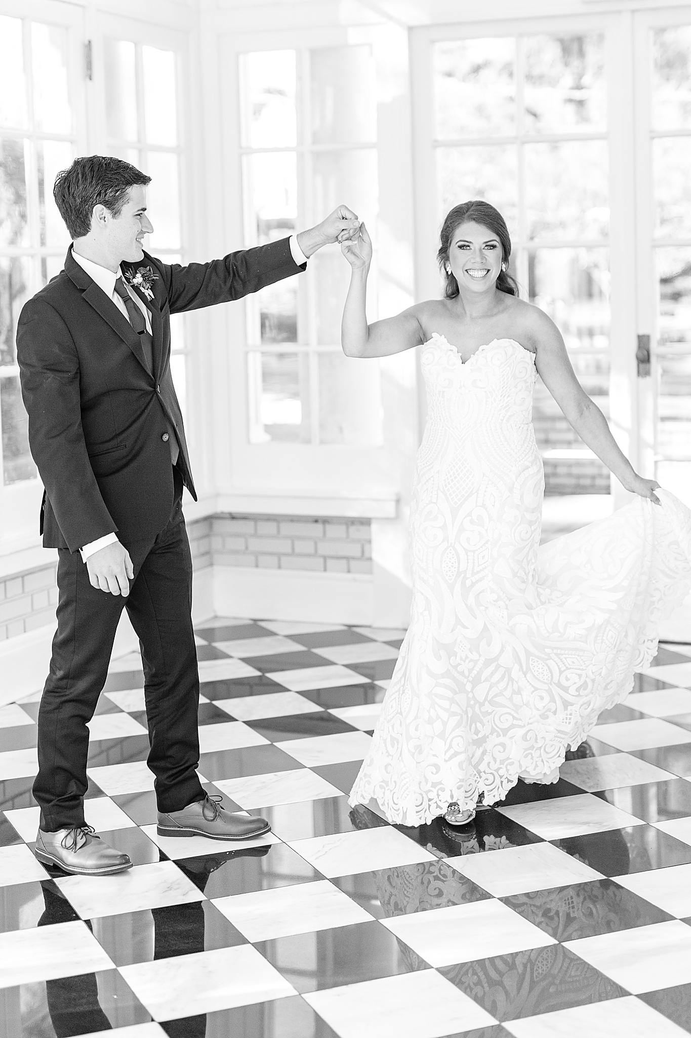 groom twirls bride during Separk Mansion wedding portraits