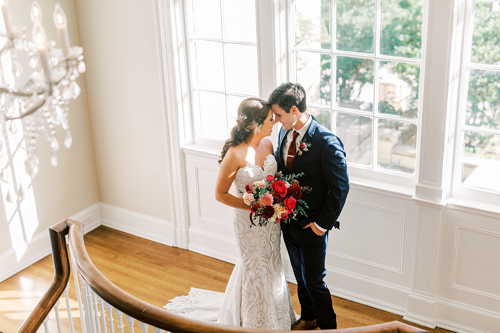 bride and groom pose on staircase in Separk Mansion