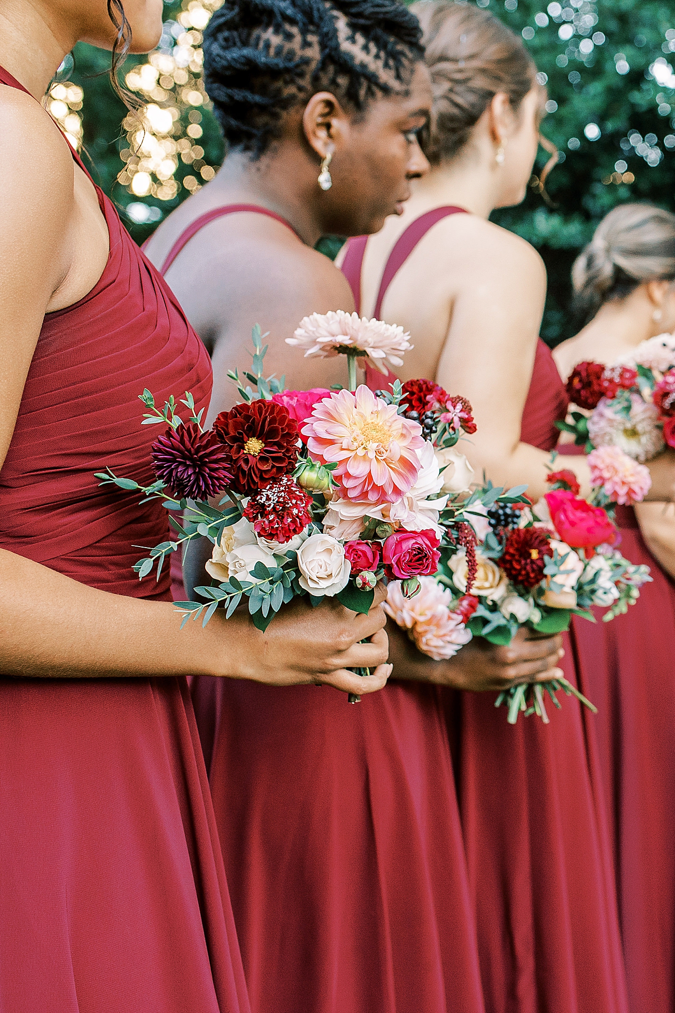 bridesmaids hold red bouquets at Separk Mansion