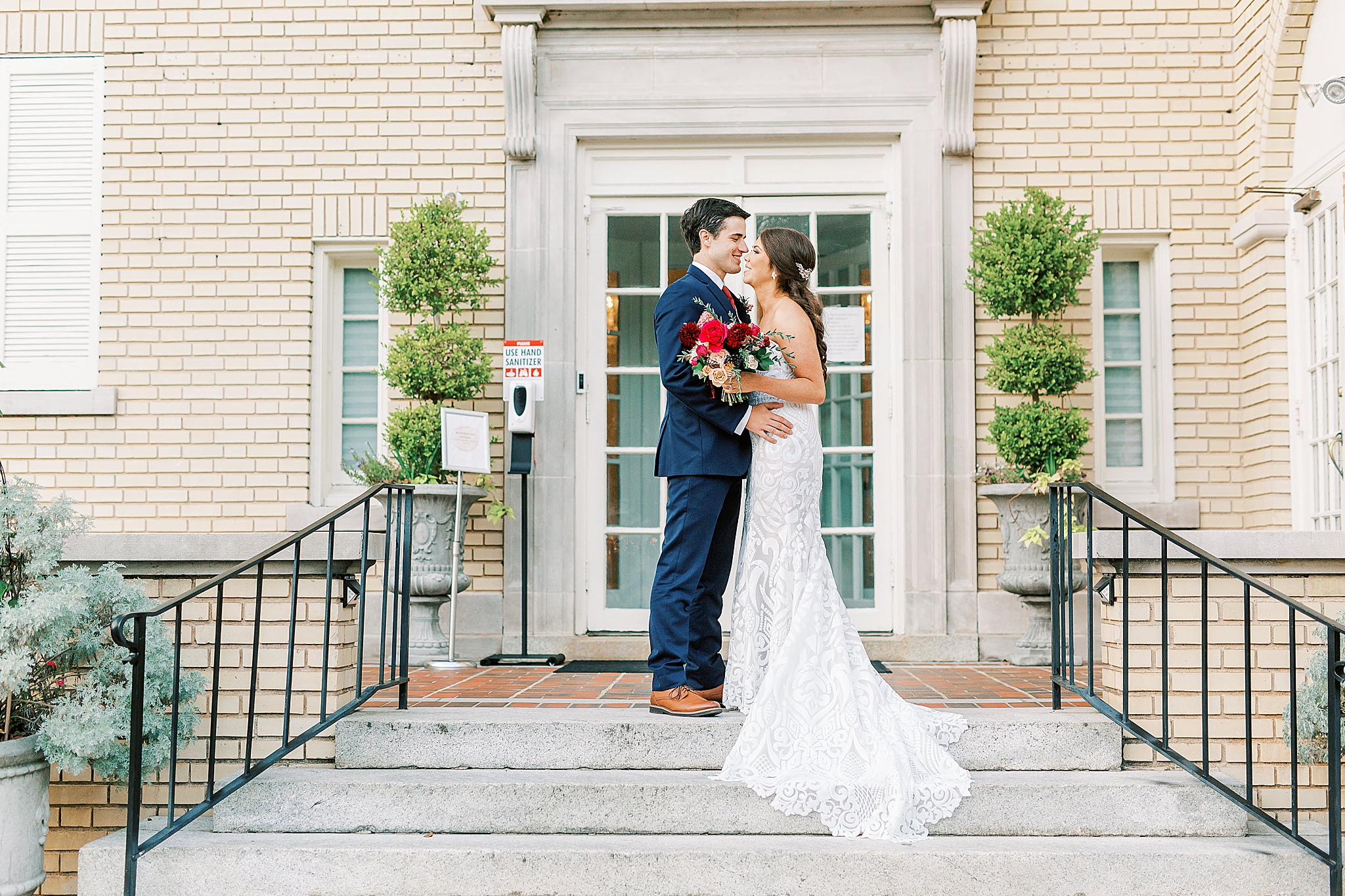bride and groom kiss on steps of Separk Mansion