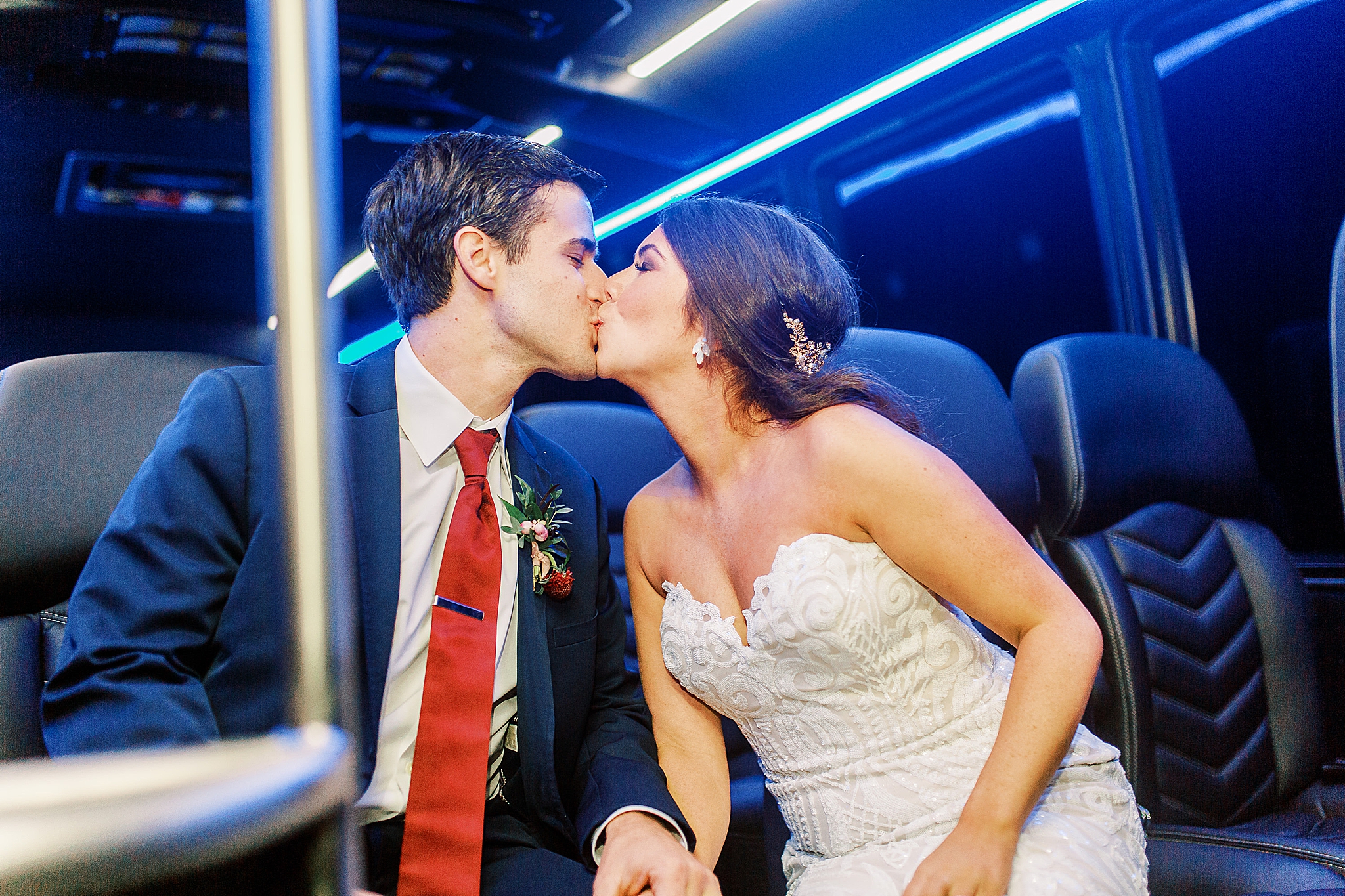 bride and groom kiss in CLT bus after wedding day