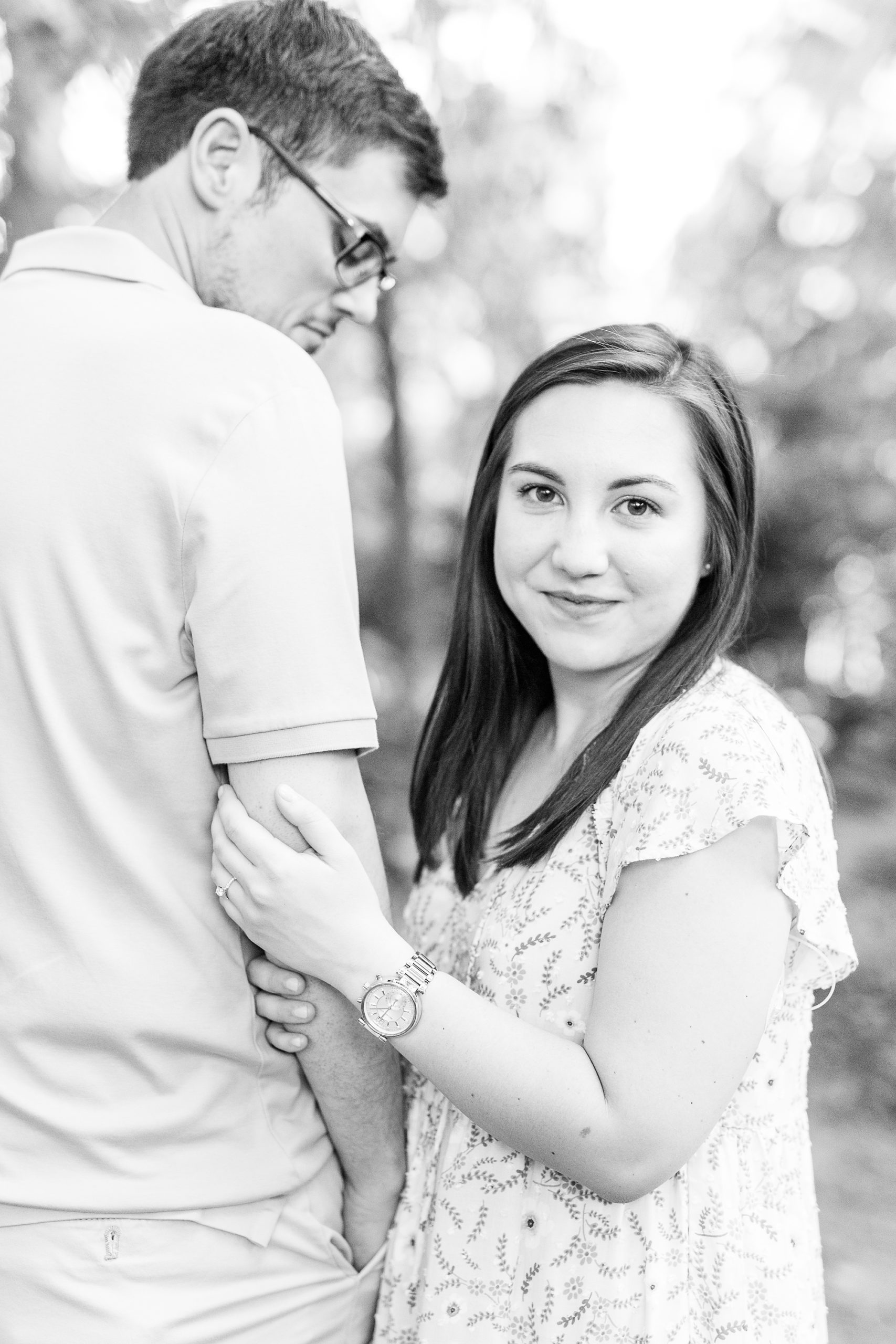 bride smiles at photographer during summer engagement session