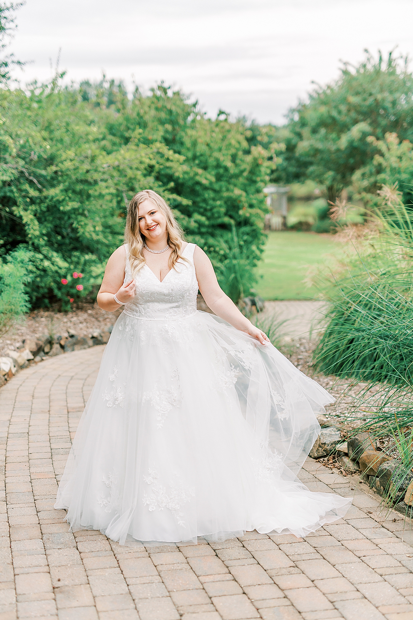 bride twirls wedding gown during The Arbors bridal portraits