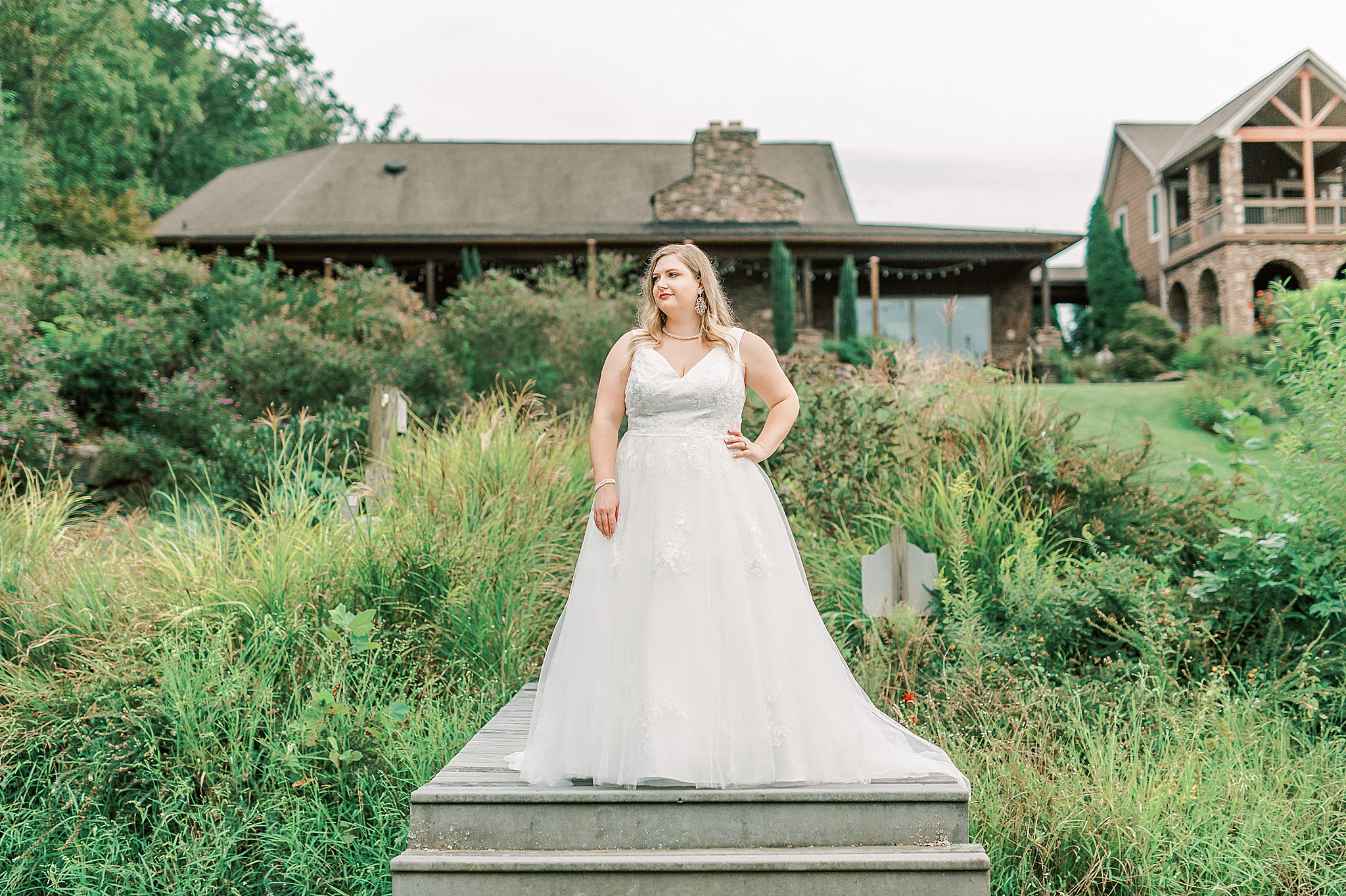 bride poses on staircase at the Arbors Wedding Venue